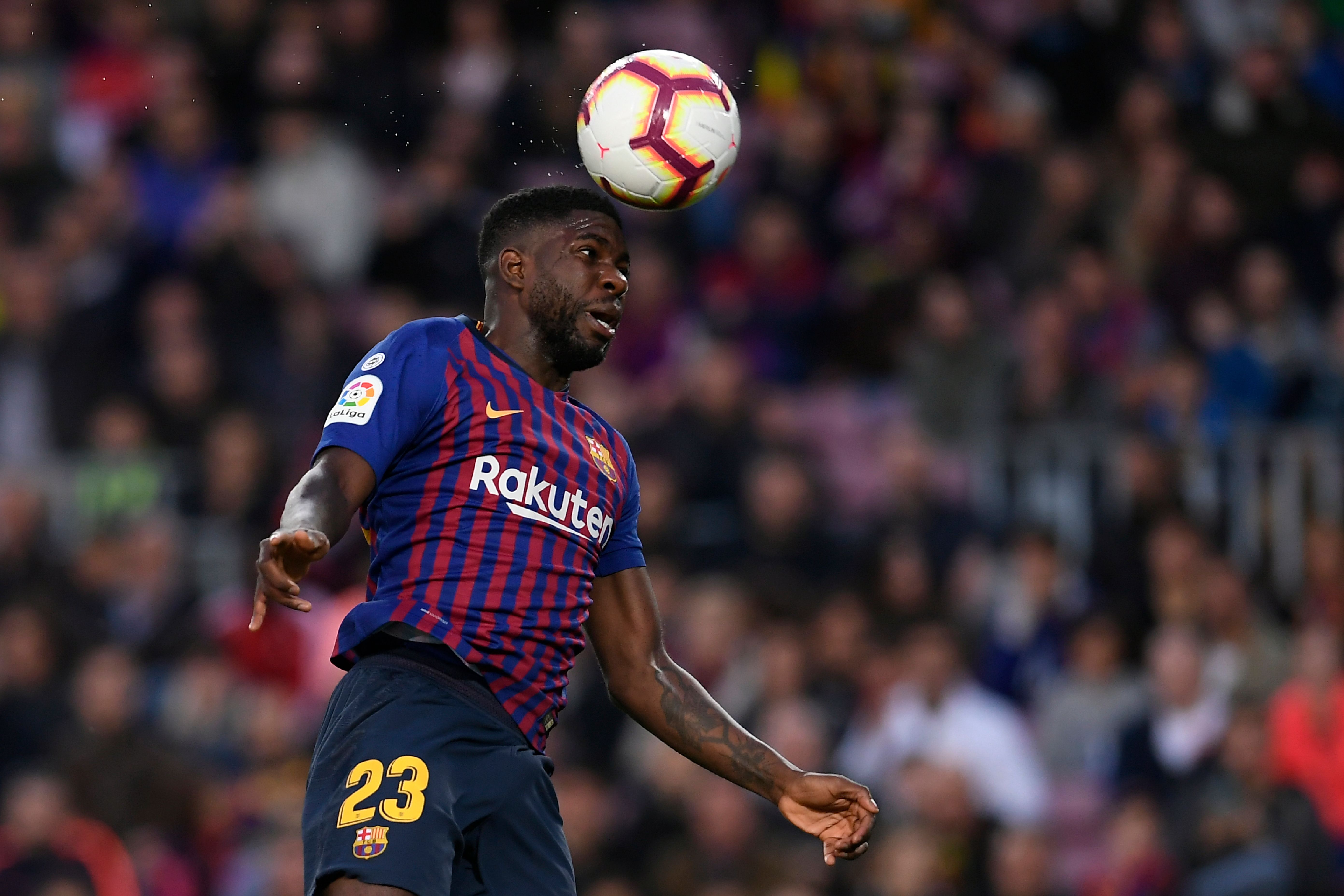Barcelona's French defender Samuel Umtiti jumps for the ball during the Spanish league football match between FC Barcelona and Rayo Vallecano de Madrid at the Camp Nou stadium in Barcelona on March 9, 2019. (Photo by LLUIS GENE / AFP)        (Photo credit should read LLUIS GENE/AFP/Getty Images)