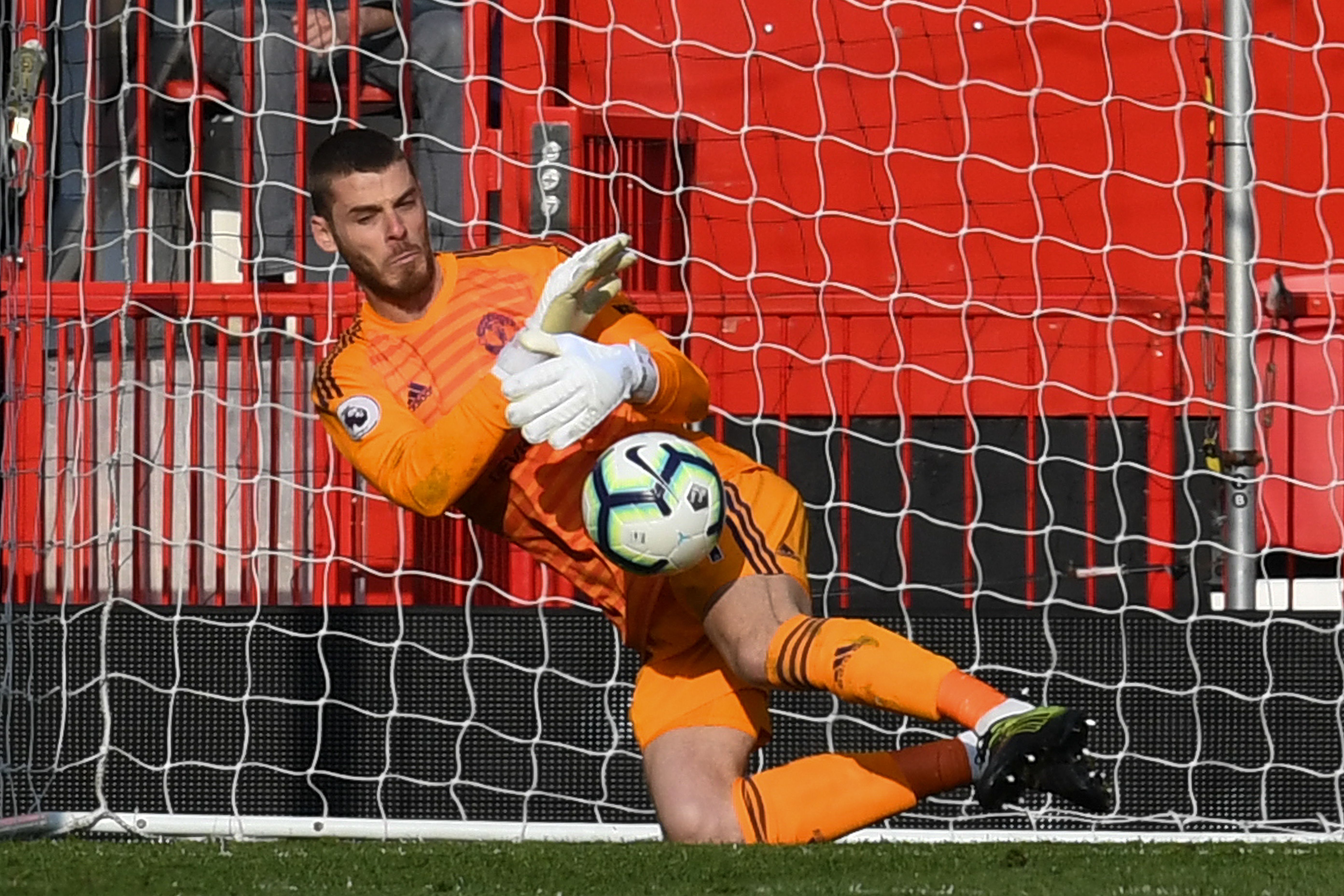 Manchester United's Spanish goalkeeper David de Gea makes a save during the English Premier League football match between Manchester United and Watford at Old Trafford in Manchester, north west England, on March 30, 2019. (Photo by Paul ELLIS / AFP) / RESTRICTED TO EDITORIAL USE. No use with unauthorized audio, video, data, fixture lists, club/league logos or 'live' services. Online in-match use limited to 120 images. An additional 40 images may be used in extra time. No video emulation. Social media in-match use limited to 120 images. An additional 40 images may be used in extra time. No use in betting publications, games or single club/league/player publications. /         (Photo credit should read PAUL ELLIS/AFP/Getty Images)