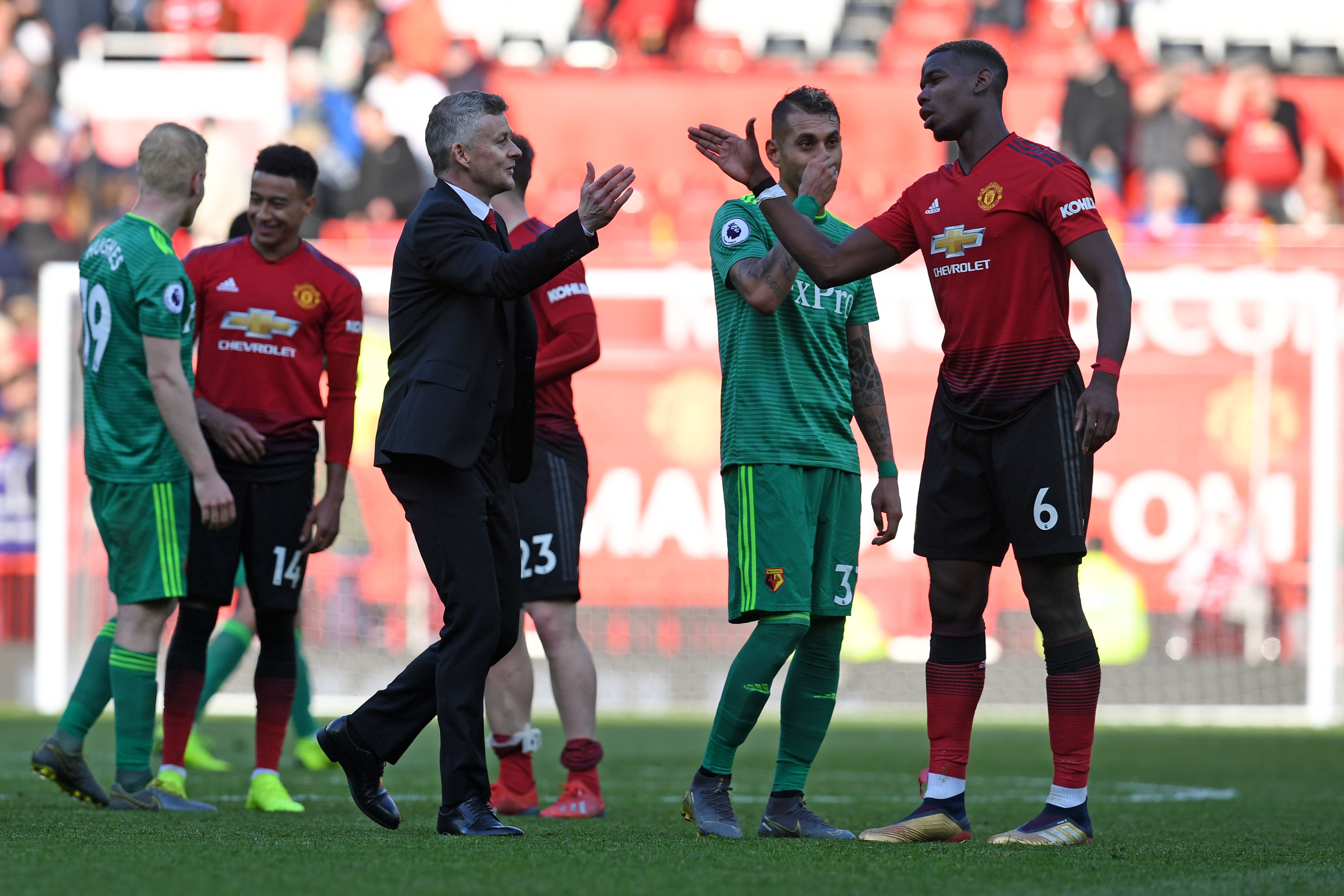 Manchester United's Norwegian manager Ole Gunnar Solskjaer (L) shakes hands with Manchester United's French midfielder Paul Pogba (R) after the final whistle of the English Premier League football match between Manchester United and Watford at Old Trafford in Manchester, north west England, on March 30, 2019. (Photo by Paul ELLIS / AFP) / RESTRICTED TO EDITORIAL USE. No use with unauthorized audio, video, data, fixture lists, club/league logos or 'live' services. Online in-match use limited to 120 images. An additional 40 images may be used in extra time. No video emulation. Social media in-match use limited to 120 images. An additional 40 images may be used in extra time. No use in betting publications, games or single club/league/player publications. /         (Photo credit should read PAUL ELLIS/AFP/Getty Images)