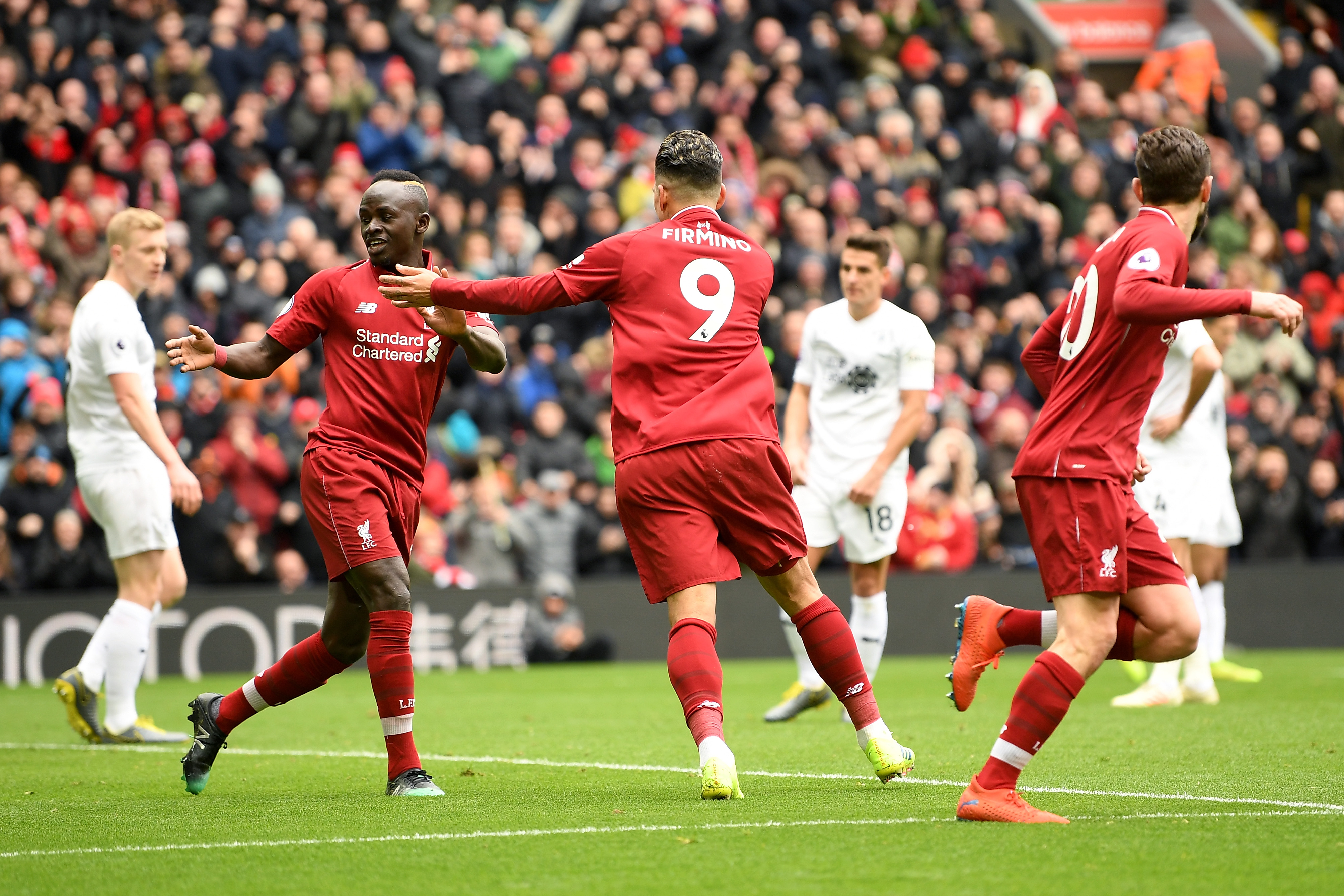 LIVERPOOL, ENGLAND - MARCH 10: Roberto Firmino of Liverpool celebrates with Sadio Mane of Liverpool after scoring his sides first goal during the Premier League match between Liverpool FC and Burnley FC at Anfield on March 10, 2019 in Liverpool, United Kingdom. (Photo by Michael Regan/Getty Images)