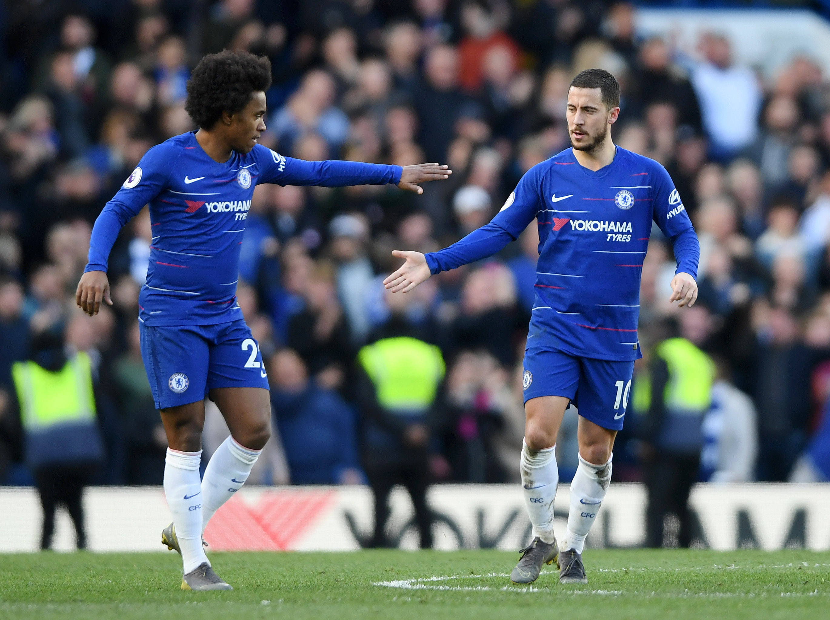 LONDON, ENGLAND - MARCH 10: Eden Hazard of Chelsea is congratulated by teammate Willian of Chelsea after scoring his team's first goal during the Premier League match between Chelsea FC and Wolverhampton Wanderers at Stamford Bridge on March 10, 2019 in London, United Kingdom. (Photo by Mike Hewitt/Getty Images)