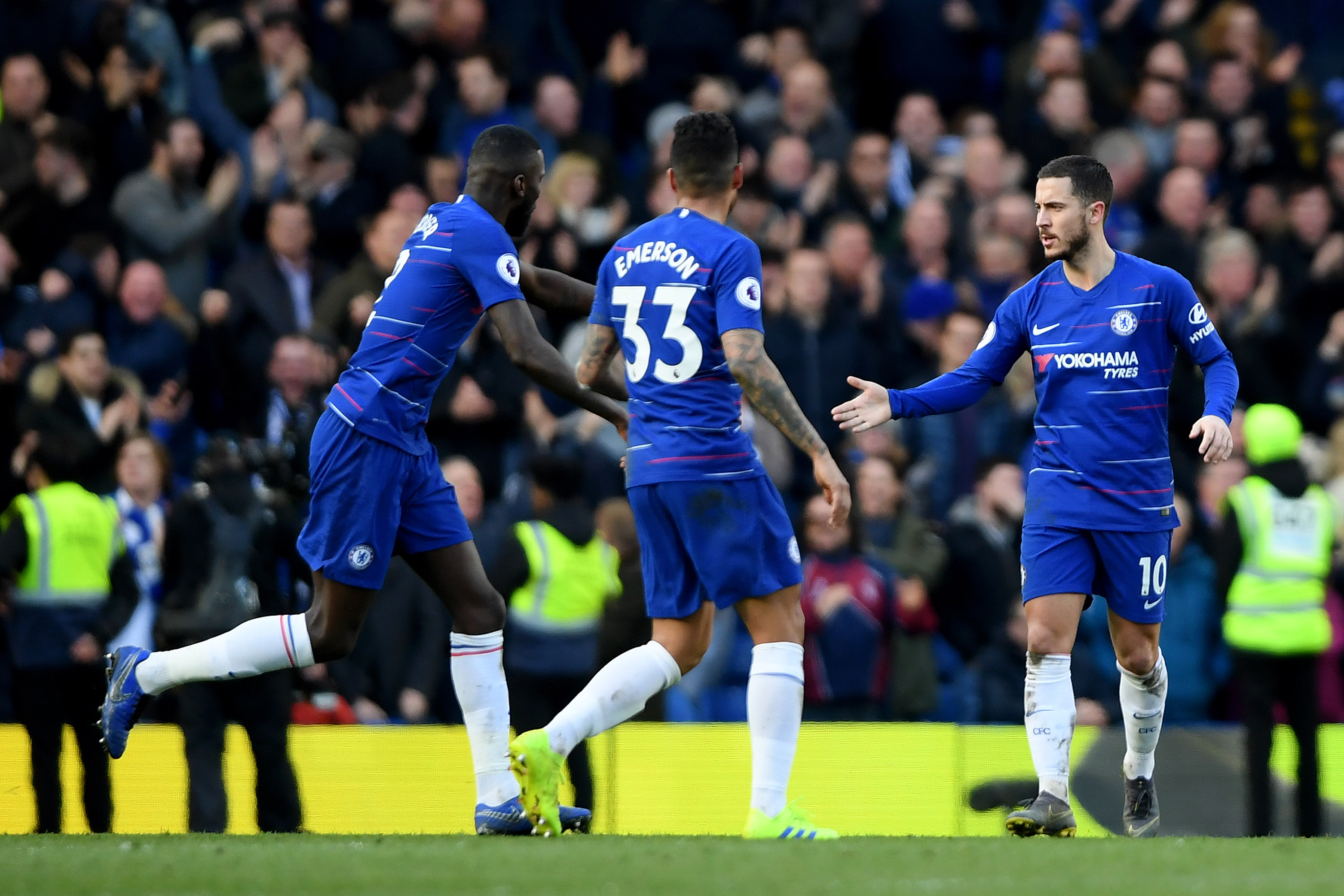 LONDON, ENGLAND - MARCH 10: Eden Hazard of Chelsea celebrates after scoring his team's first goal with teammates Emerson and Antonio Ruediger during the Premier League match between Chelsea FC and Wolverhampton Wanderers at Stamford Bridge on March 10, 2019 in London, United Kingdom. (Photo by Mike Hewitt/Getty Images)