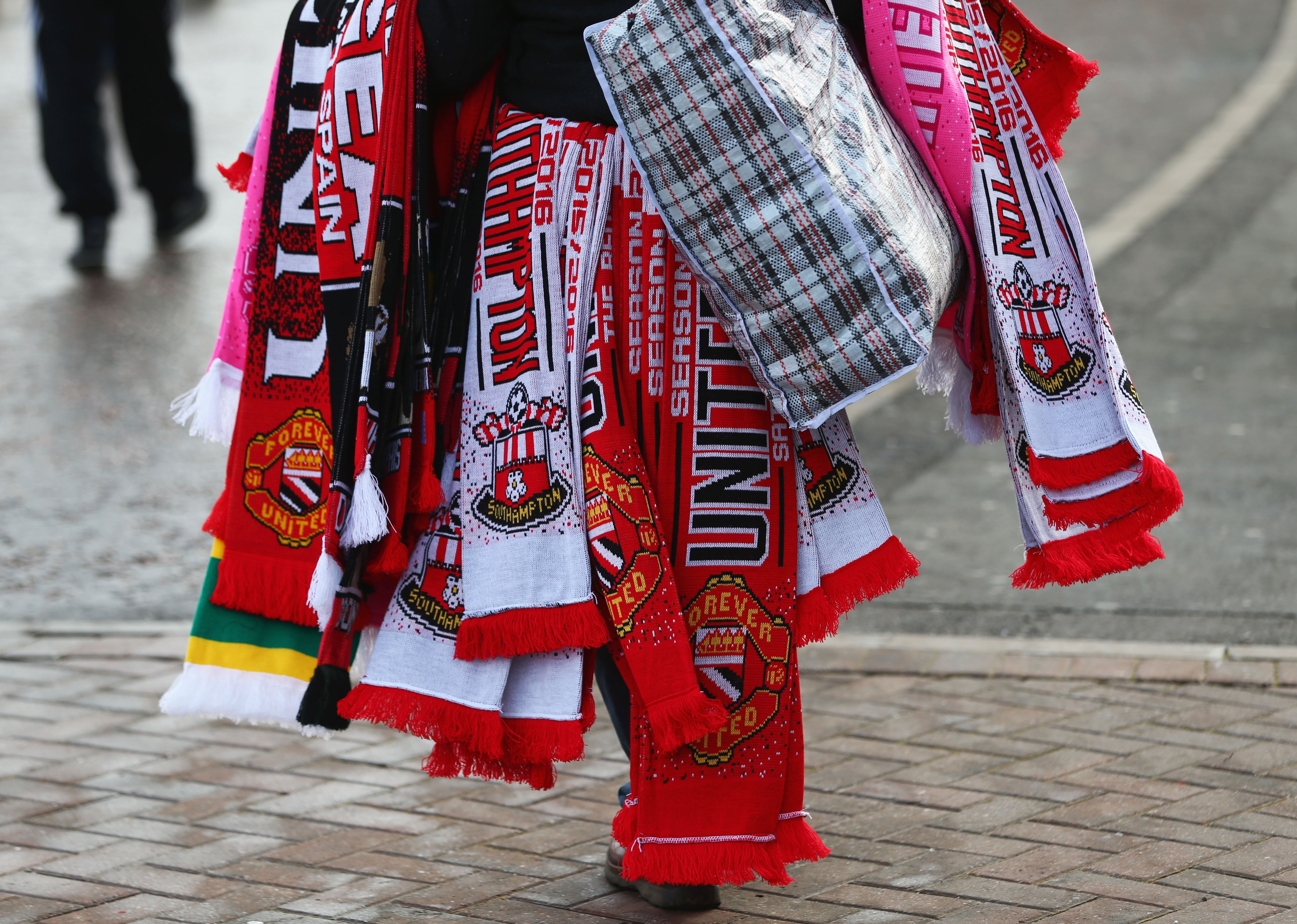 MANCHESTER, ENGLAND - JANUARY 23: Matchday scarves are on sale outside the stadium prior to the Barclays Premier League match between Manchester United and Southampton at Old Trafford on January 23, 2016 in Manchester, England.  (Photo by Michael Steele/Getty Images)