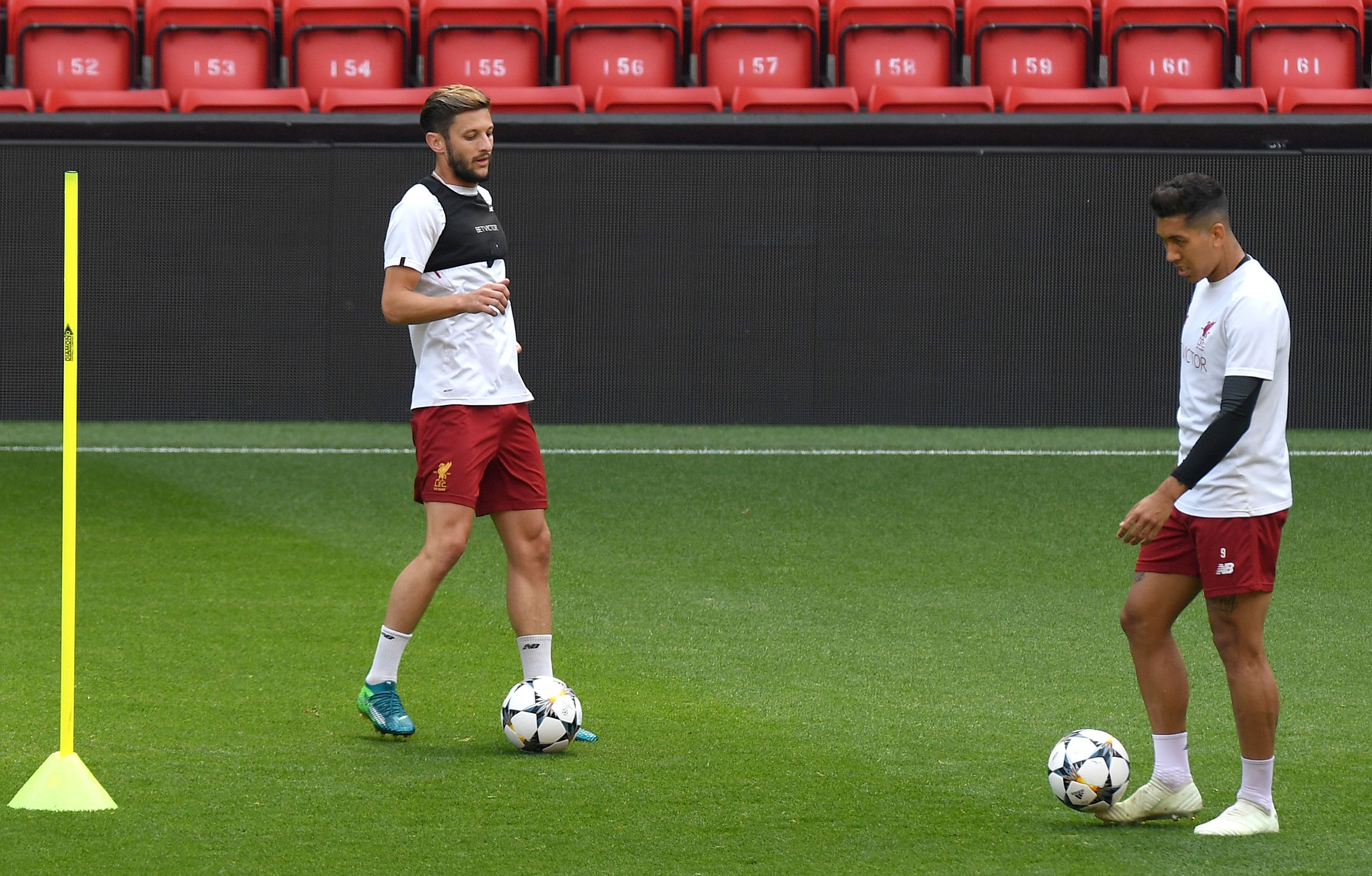 Liverpool's English midfielder Adam Lallana (L) and Liverpool's Brazilian midfielder Roberto Firmino attend a training session and media day at Anfield stadium in Liverpool, north west England on May 21, 2018, ahead of their UEFA Champions League final football match against Real Madrid in Kiev on May 26. (Photo by Paul ELLIS / AFP)        (Photo credit should read PAUL ELLIS/AFP/Getty Images)