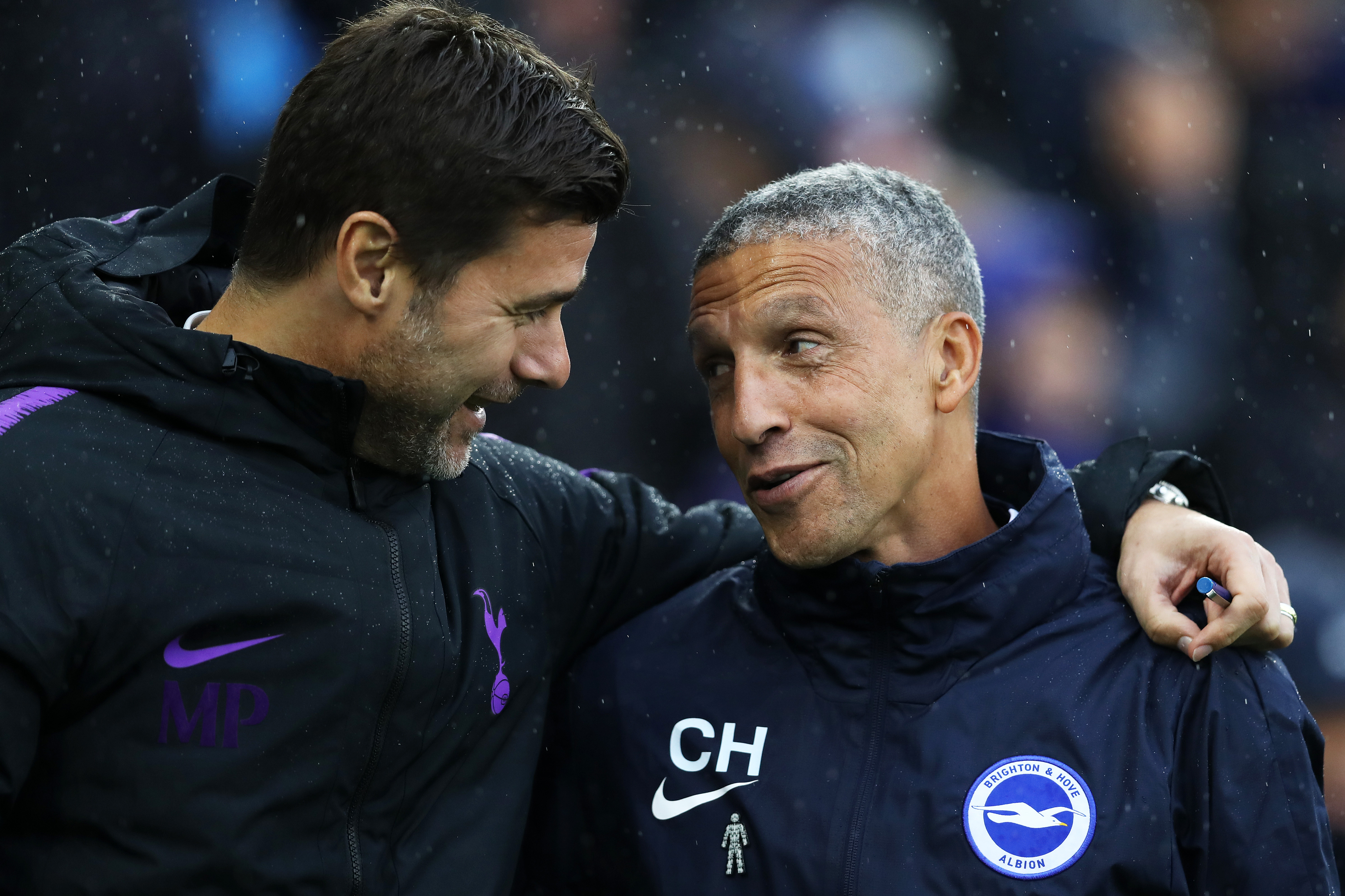 BRIGHTON, ENGLAND - SEPTEMBER 22:  Mauricio Pochettino, Manager of Tottenham Hotspur and Chris Hughton, Manager of Brighton and Hove Albion embrace prior to the Premier League match between Brighton & Hove Albion and Tottenham Hotspur at American Express Community Stadium on September 22, 2018 in Brighton, United Kingdom.  (Photo by Dan Istitene/Getty Images)