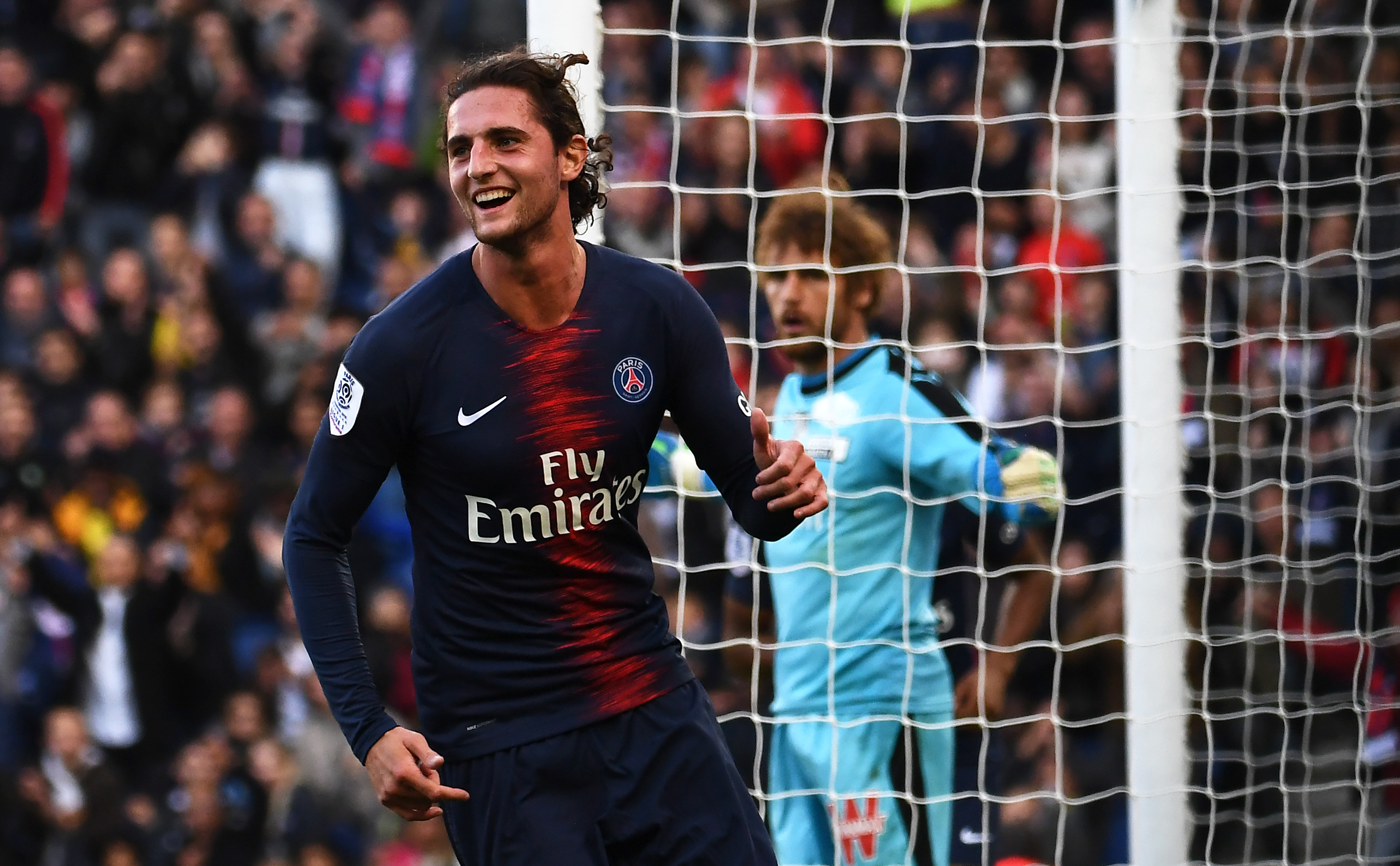 Paris Saint-Germain's French midfielder Adrien Rabiot celebrates after scoring his team's second goal during the French L1 football match between Paris Saint-Germain (PSG) and Amiens at the Parc des Princes stadium in Paris on October 20, 2018. (Photo by Anne-Christine POUJOULAT / AFP)        (Photo credit should read ANNE-CHRISTINE POUJOULAT/AFP/Getty Images)