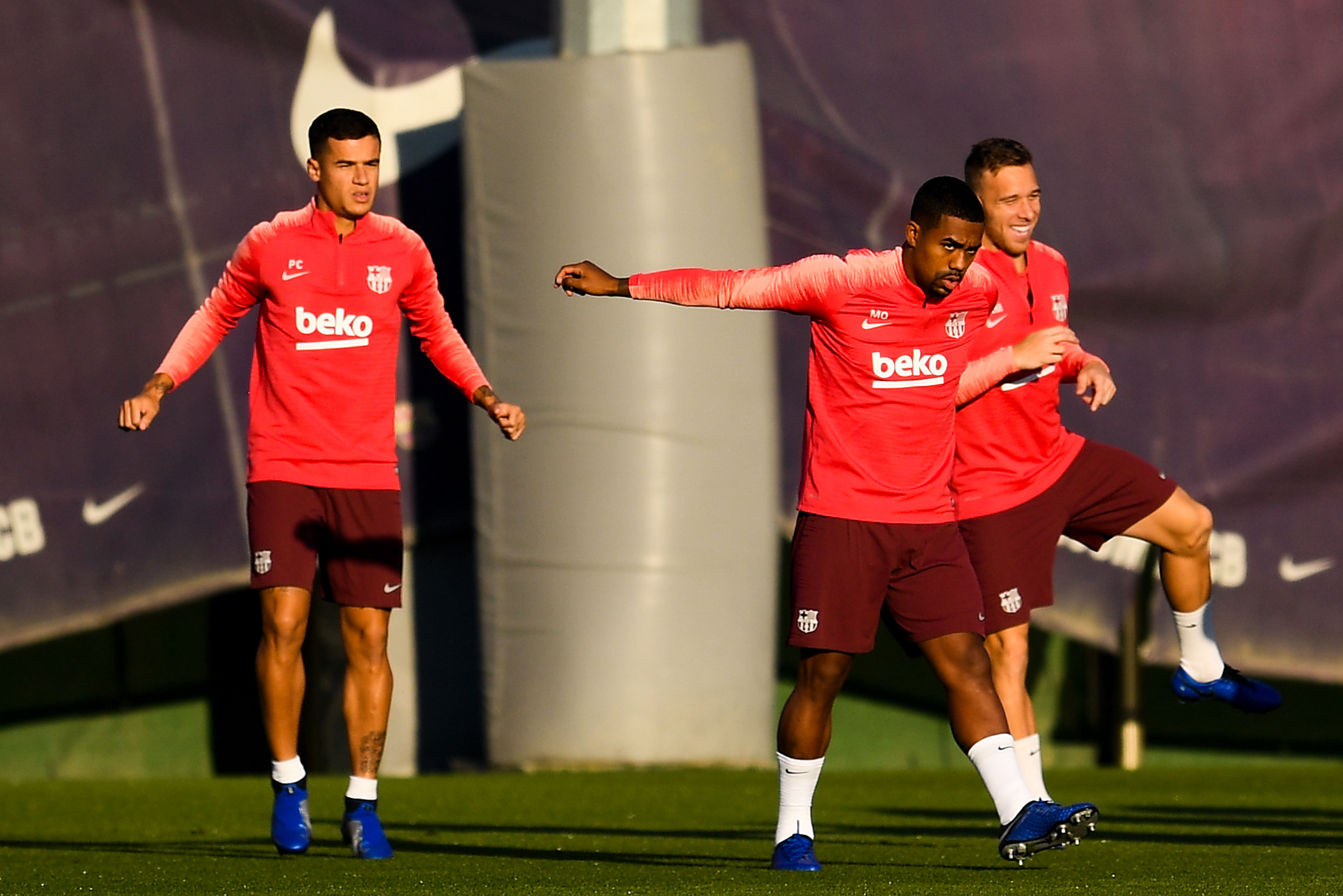 SANT JOAN DESPI, SPAIN - OCTOBER 23:  (L-R) Philippe Coutinho, Malcom and Arthur of FC Barcelona warm up during a training session ahead of the UEFA Champions League Group B match between FC Barcelona and FC Internazionale at Ciutat Esportiva Joan Gamper on October 23, 2018 in Sant Joan Despi, Spain.  (Photo by David Ramos/Getty Images)