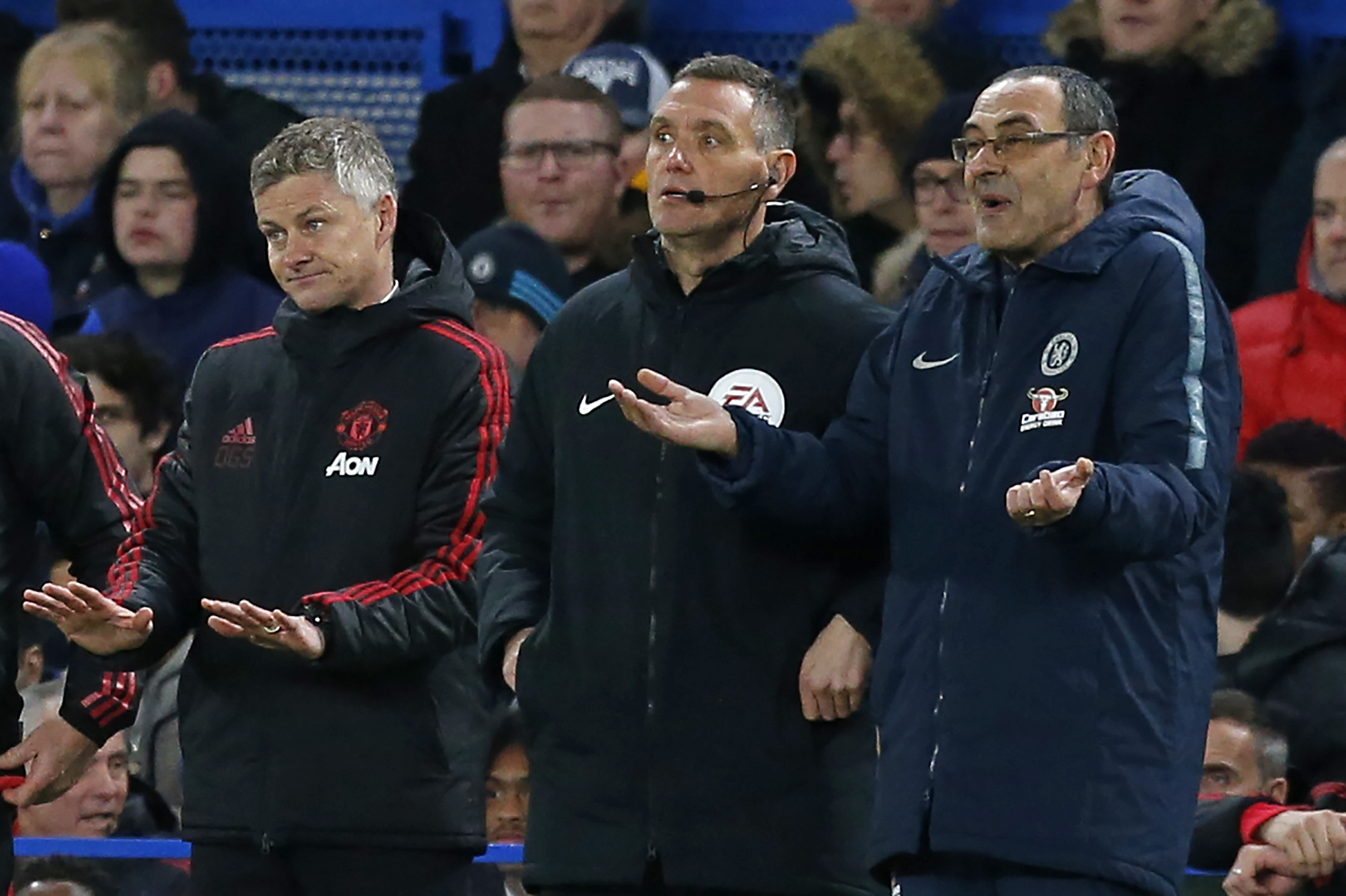 Manchester United's  Norwegian caretaker manager Ole Gunnar Solskjaer (L) and Chelsea's Italian head coach Maurizio Sarri (R) gesture on the touchline during the English FA Cup fifth round football match between Chelsea and Manchester United at Stamford Bridge in London on February 18, 2019. (Photo by Ian KINGTON / AFP) / RESTRICTED TO EDITORIAL USE. No use with unauthorized audio, video, data, fixture lists, club/league logos or 'live' services. Online in-match use limited to 120 images. An additional 40 images may be used in extra time. No video emulation. Social media in-match use limited to 120 images. An additional 40 images may be used in extra time. No use in betting publications, games or single club/league/player publications. /         (Photo credit should read IAN KINGTON/AFP/Getty Images)