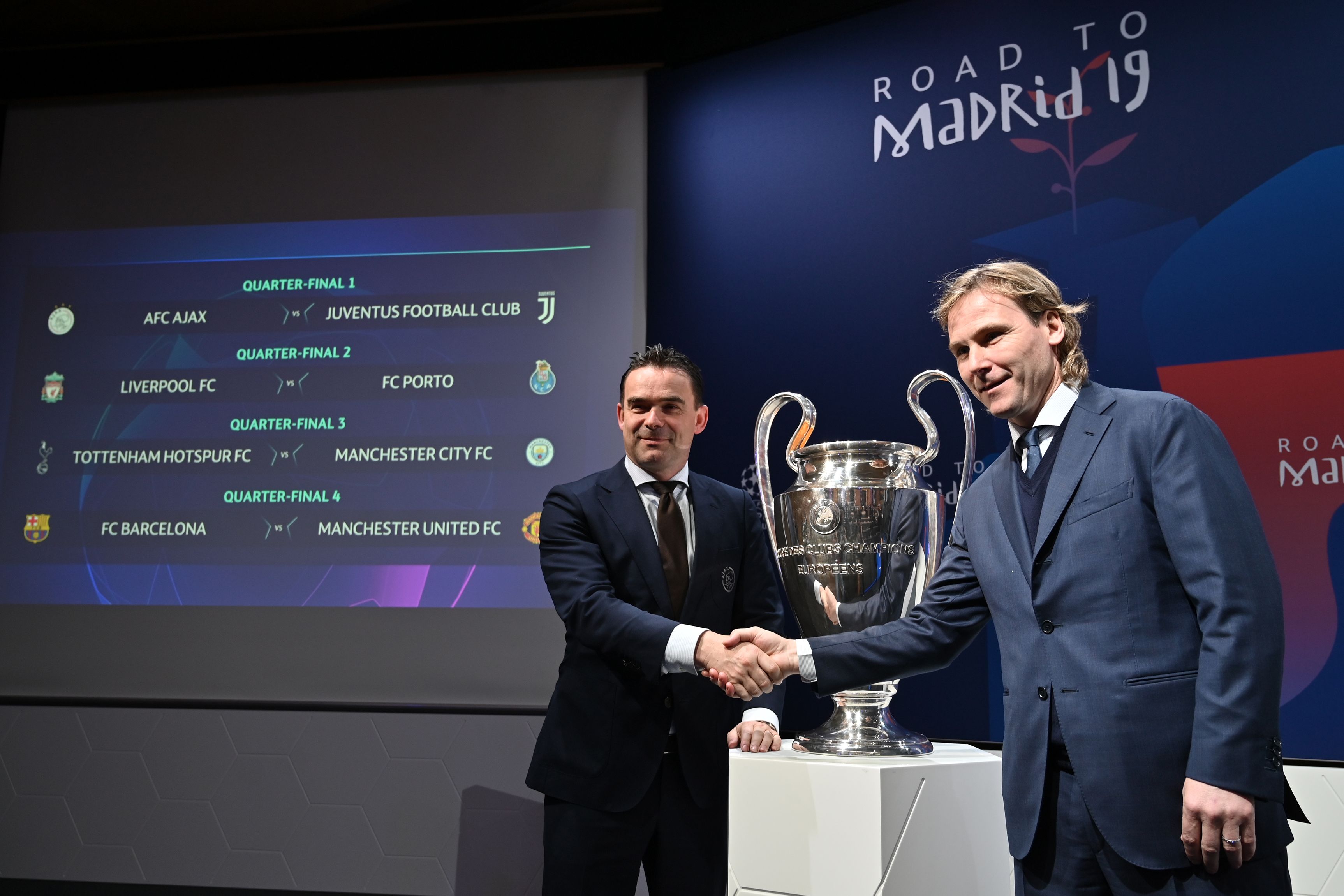 Juventus football club ambassador Pavel Nedved (R) shakes hands with Ajax director of football Marc Overmars next to results of the draw for the Champions league quarter-final and the competition's trophy, on March 15, 2019 in Nyon. (Photo by Fabrice COFFRINI / AFP)        (Photo credit should read FABRICE COFFRINI/AFP/Getty Images)