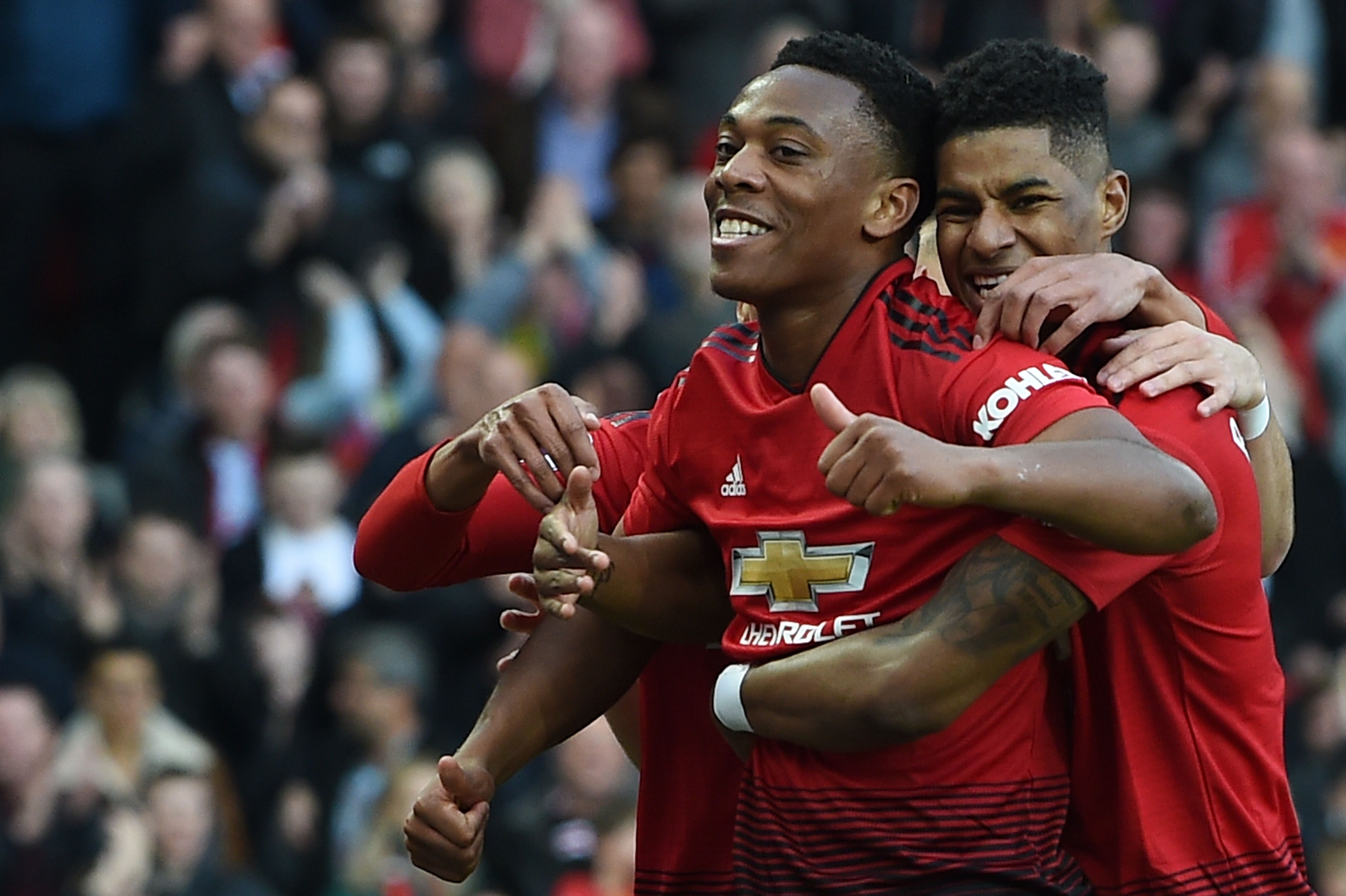 Manchester United's French forward Anthony Martial (C) celebrates scoring their second goal with Manchester United's English forward Marcus Rashford (R), and Manchester United's English midfielder Jesse Lingard (L) during the English Premier League football match between Manchester United and Watford at Old Trafford in Manchester, north west England, on March 30, 2019. (Photo by Paul ELLIS / AFP) / RESTRICTED TO EDITORIAL USE. No use with unauthorized audio, video, data, fixture lists, club/league logos or 'live' services. Online in-match use limited to 120 images. An additional 40 images may be used in extra time. No video emulation. Social media in-match use limited to 120 images. An additional 40 images may be used in extra time. No use in betting publications, games or single club/league/player publications. /         (Photo credit should read PAUL ELLIS/AFP/Getty Images)