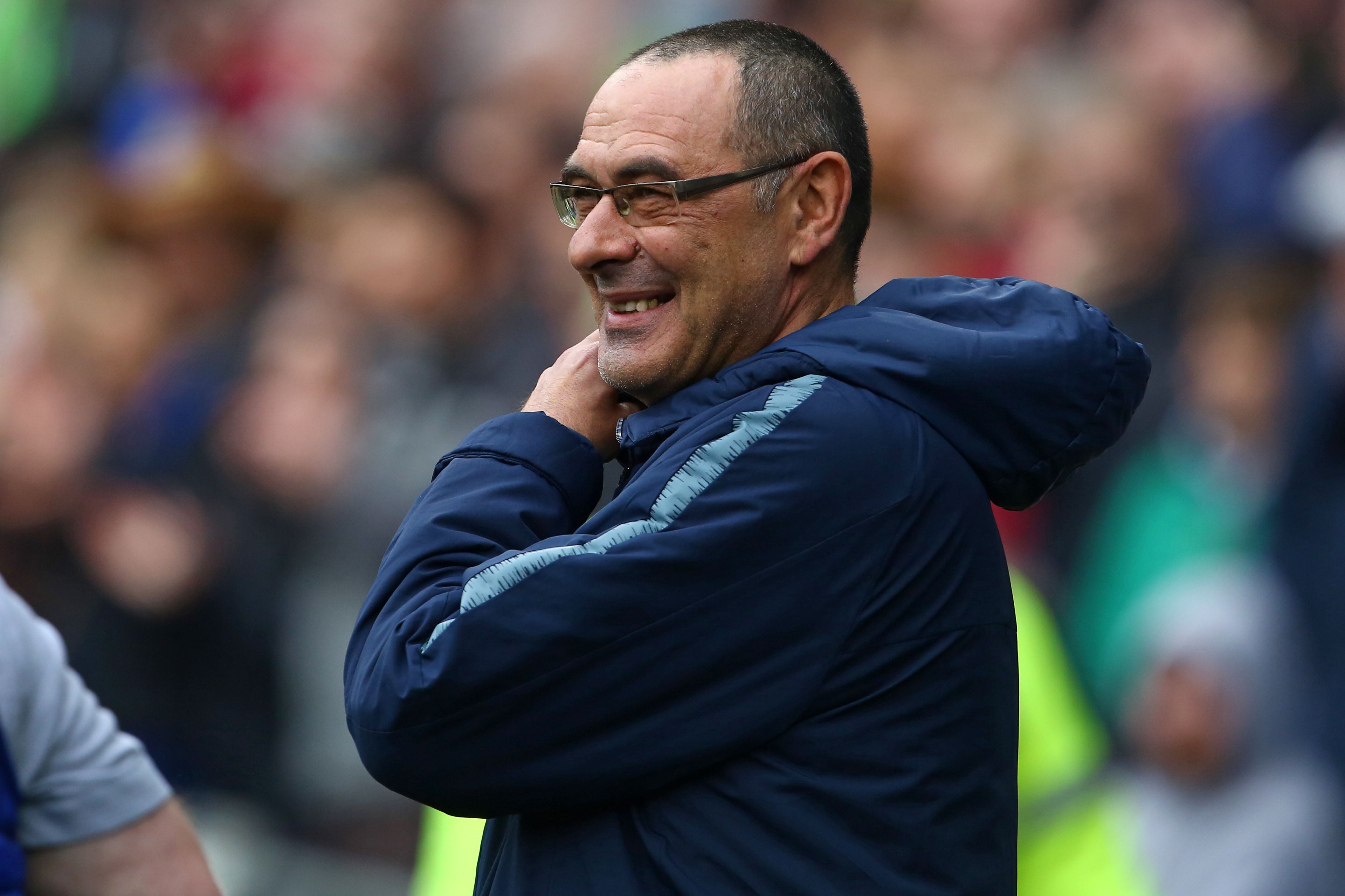 Chelsea's Italian head coach Maurizio Sarri smiles ahead of the English Premier League football match between between Cardiff City and Chelsea at Cardiff City Stadium in Cardiff, south Wales on March 31, 2019. (Photo by Geoff CADDICK / AFP) / RESTRICTED TO EDITORIAL USE. No use with unauthorized audio, video, data, fixture lists, club/league logos or 'live' services. Online in-match use limited to 120 images. An additional 40 images may be used in extra time. No video emulation. Social media in-match use limited to 120 images. An additional 40 images may be used in extra time. No use in betting publications, games or single club/league/player publications. /         (Photo credit should read GEOFF CADDICK/AFP/Getty Images)