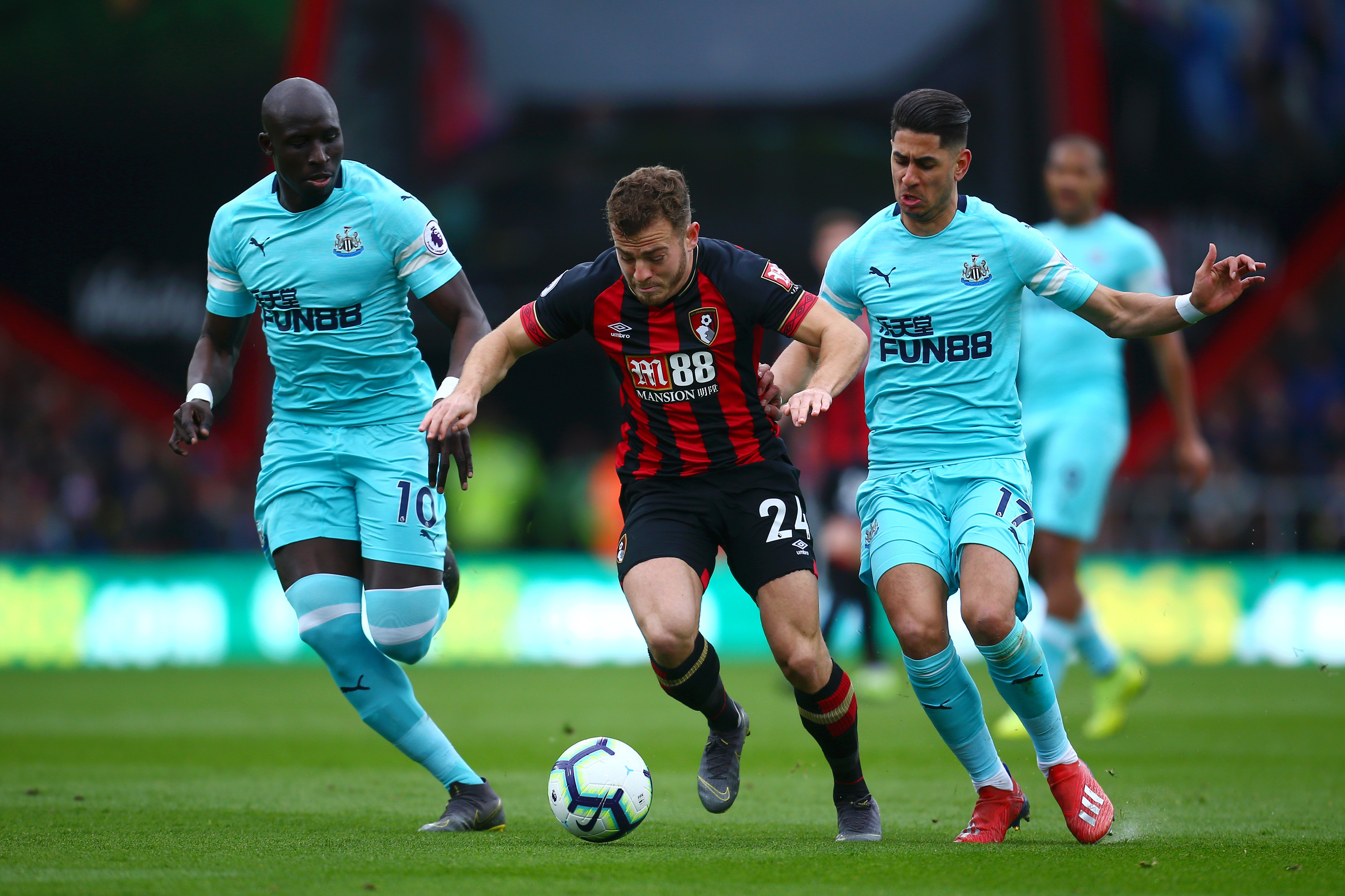 BOURNEMOUTH, ENGLAND - MARCH 16: Ryan Fraser of AFC Bournemouth is challenged by Ayoze Perez of Newcastle United and Mohamed Diame of Newcastle United  during the Premier League match between AFC Bournemouth and Newcastle United at Vitality Stadium on March 16, 2019 in Bournemouth, United Kingdom. (Photo by Jordan Mansfield/Getty Images)