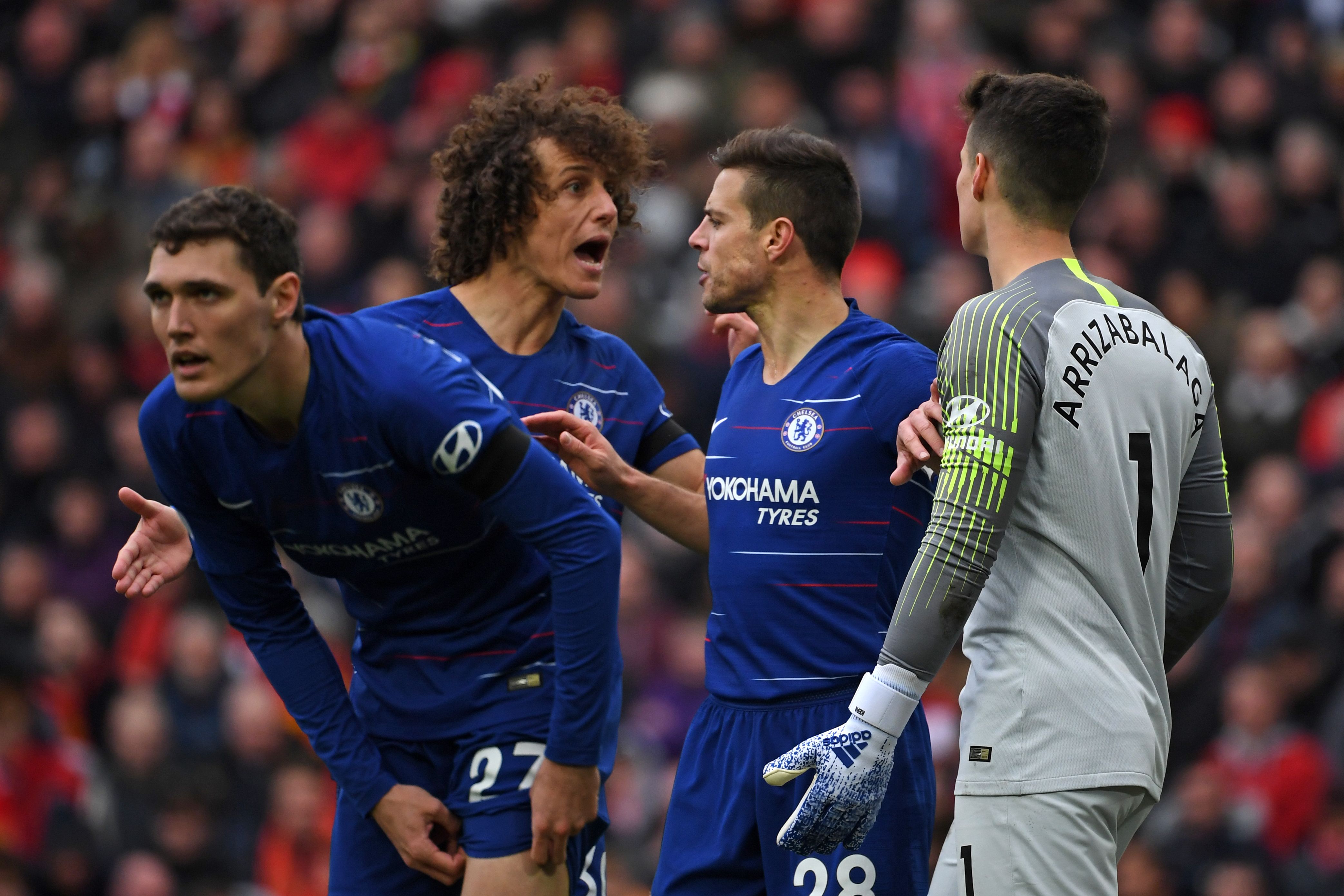 Chelsea's Spanish defender Cesar Azpilicueta (2nd R) comes between Chelsea's Brazilian defender David Luiz (2nd L) and Chelsea's Spanish goalkeeper Kepa Arrizabalaga (R) during the English Premier League football match between Liverpool and Chelsea at Anfield in Liverpool, north west England on April 14, 2019. (Photo by Paul ELLIS / AFP) / RESTRICTED TO EDITORIAL USE. No use with unauthorized audio, video, data, fixture lists, club/league logos or 'live' services. Online in-match use limited to 120 images. An additional 40 images may be used in extra time. No video emulation. Social media in-match use limited to 120 images. An additional 40 images may be used in extra time. No use in betting publications, games or single club/league/player publications. /         (Photo credit should read PAUL ELLIS/AFP/Getty Images)