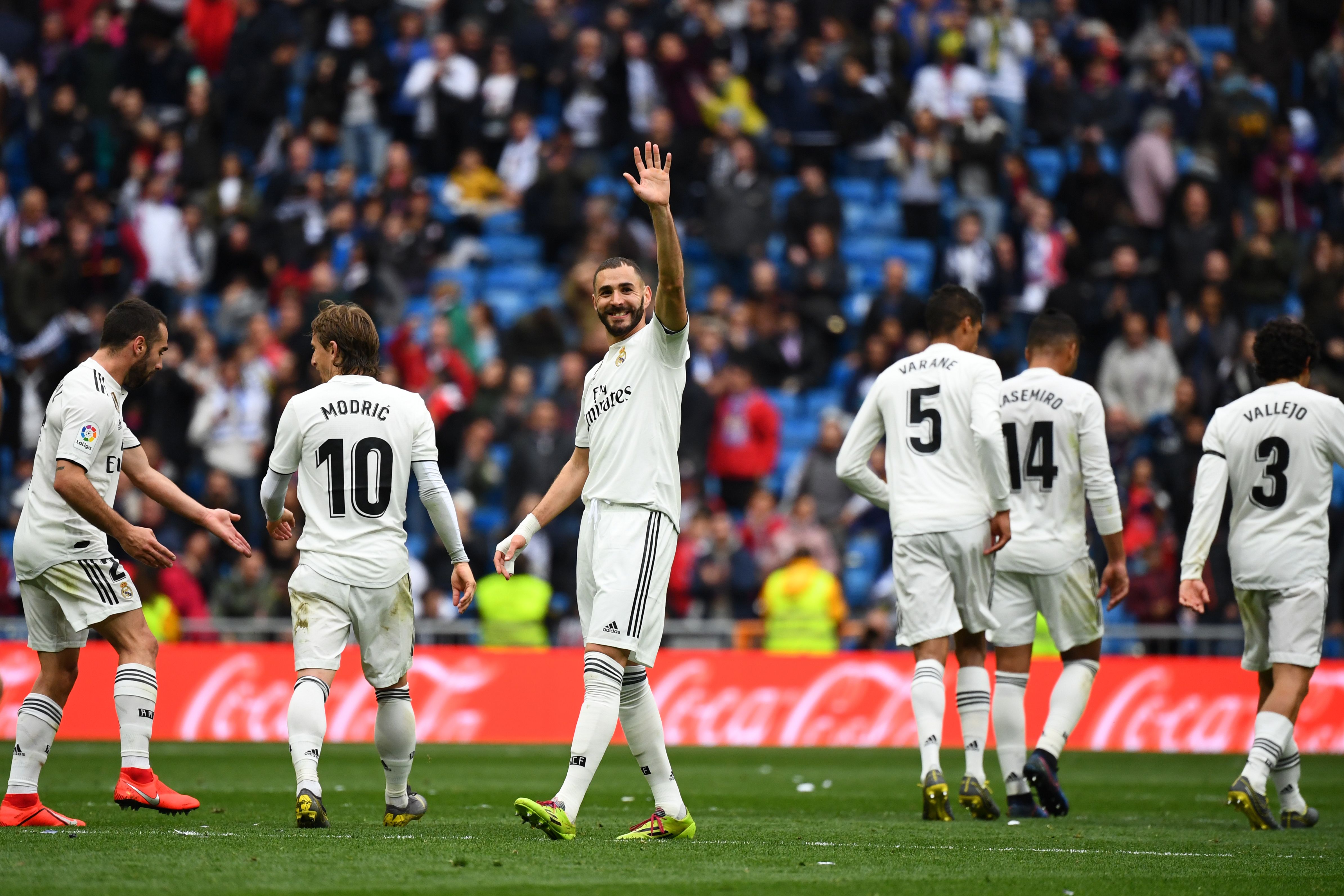 Real Madrid's French forward Karim Benzema (C) celebrates with teammates after scoring his third goal during the Spanish League football match between Real Madrid and Athletic Bilbao at the Santiago Bernabeu Stadium in Madrid on April 21, 2019. (Photo by GABRIEL BOUYS / AFP)        (Photo credit should read GABRIEL BOUYS/AFP/Getty Images)