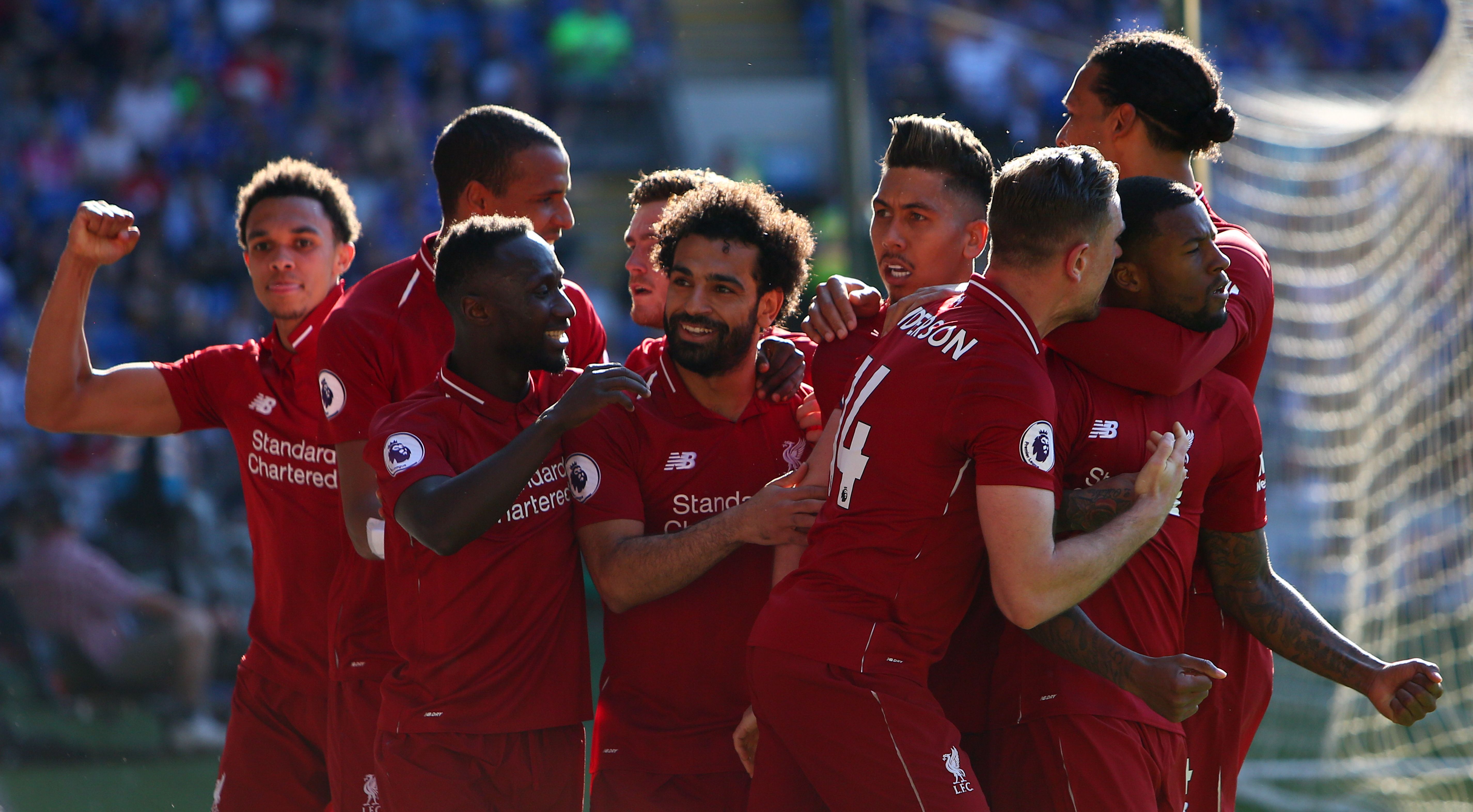 Liverpool's Dutch midfielder Georginio Wijnaldum (R) celebrates scoring the opening goal during the English Premier League football match between between Cardiff City and Liverpool at Cardiff City Stadium in Cardiff, south Wales on April 21, 2019. (Photo by GEOFF CADDICK / AFP) / RESTRICTED TO EDITORIAL USE. No use with unauthorized audio, video, data, fixture lists, club/league logos or 'live' services. Online in-match use limited to 120 images. An additional 40 images may be used in extra time. No video emulation. Social media in-match use limited to 120 images. An additional 40 images may be used in extra time. No use in betting publications, games or single club/league/player publications. /         (Photo credit should read GEOFF CADDICK/AFP/Getty Images)