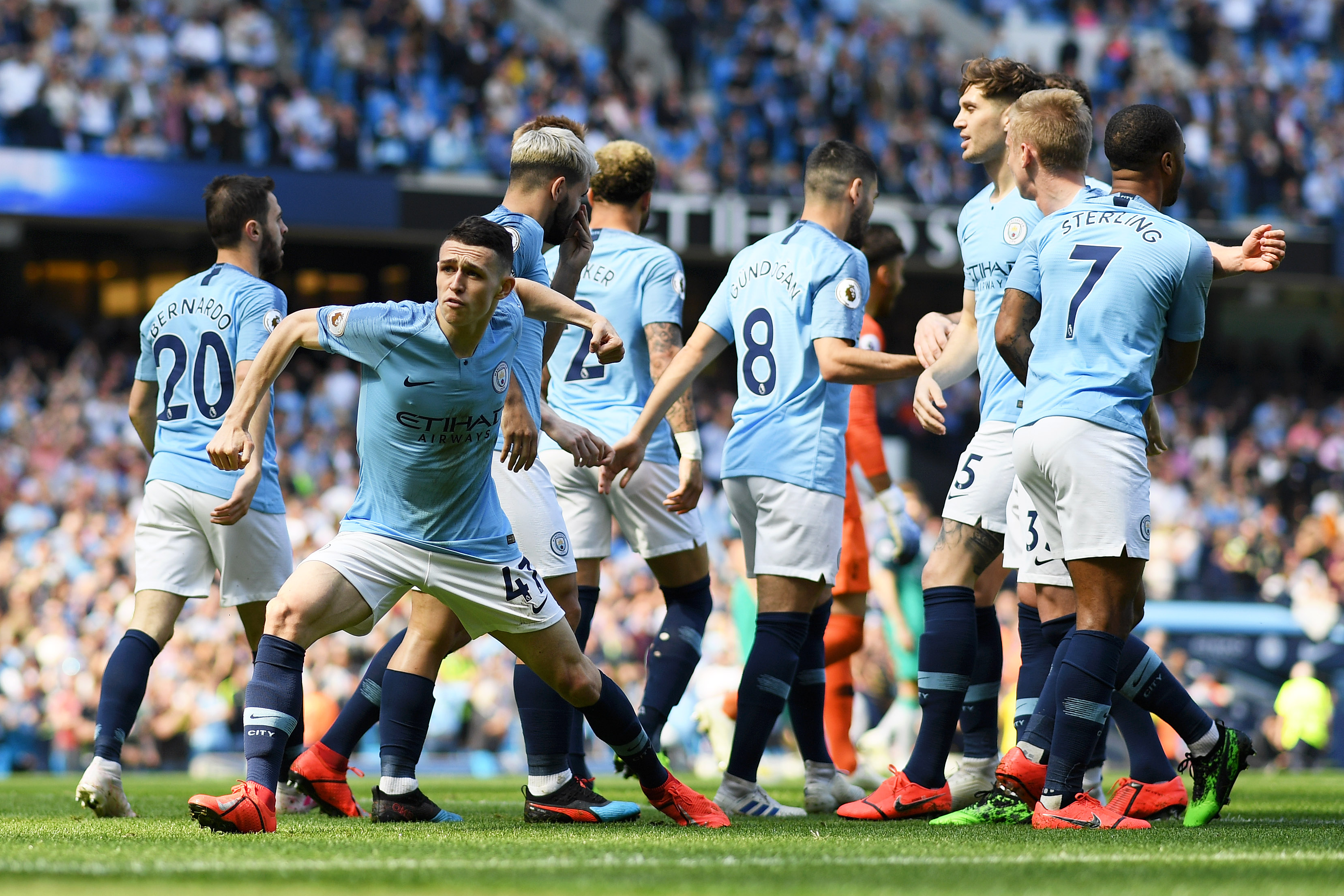 MANCHESTER, ENGLAND - APRIL 20:   Phil Foden of Manchester City celebrates with teammates after scoring his team's first goal during the Premier League match between Manchester City and Tottenham Hotspur at Etihad Stadium on April 20, 2019 in Manchester, United Kingdom. (Photo by Shaun Botterill/Getty Images)