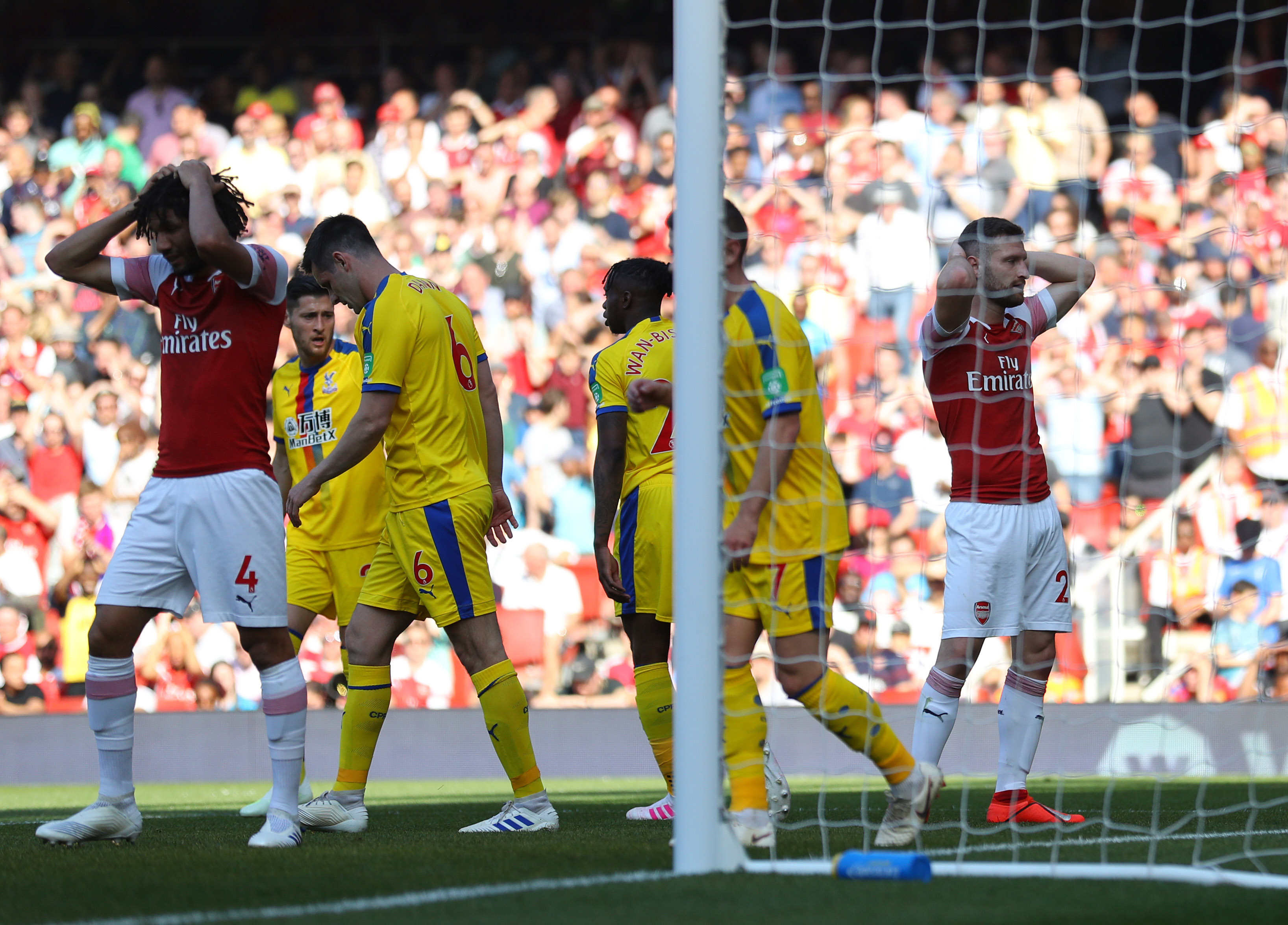 LONDON, ENGLAND - APRIL 21:  Shkodran Mustafi (20) and Mohamed Elneny of Arsenal (4) react during the Premier League match between Arsenal FC and Crystal Palace at Emirates Stadium on April 21, 2019 in London, United Kingdom. (Photo by Warren Little/Getty Images)