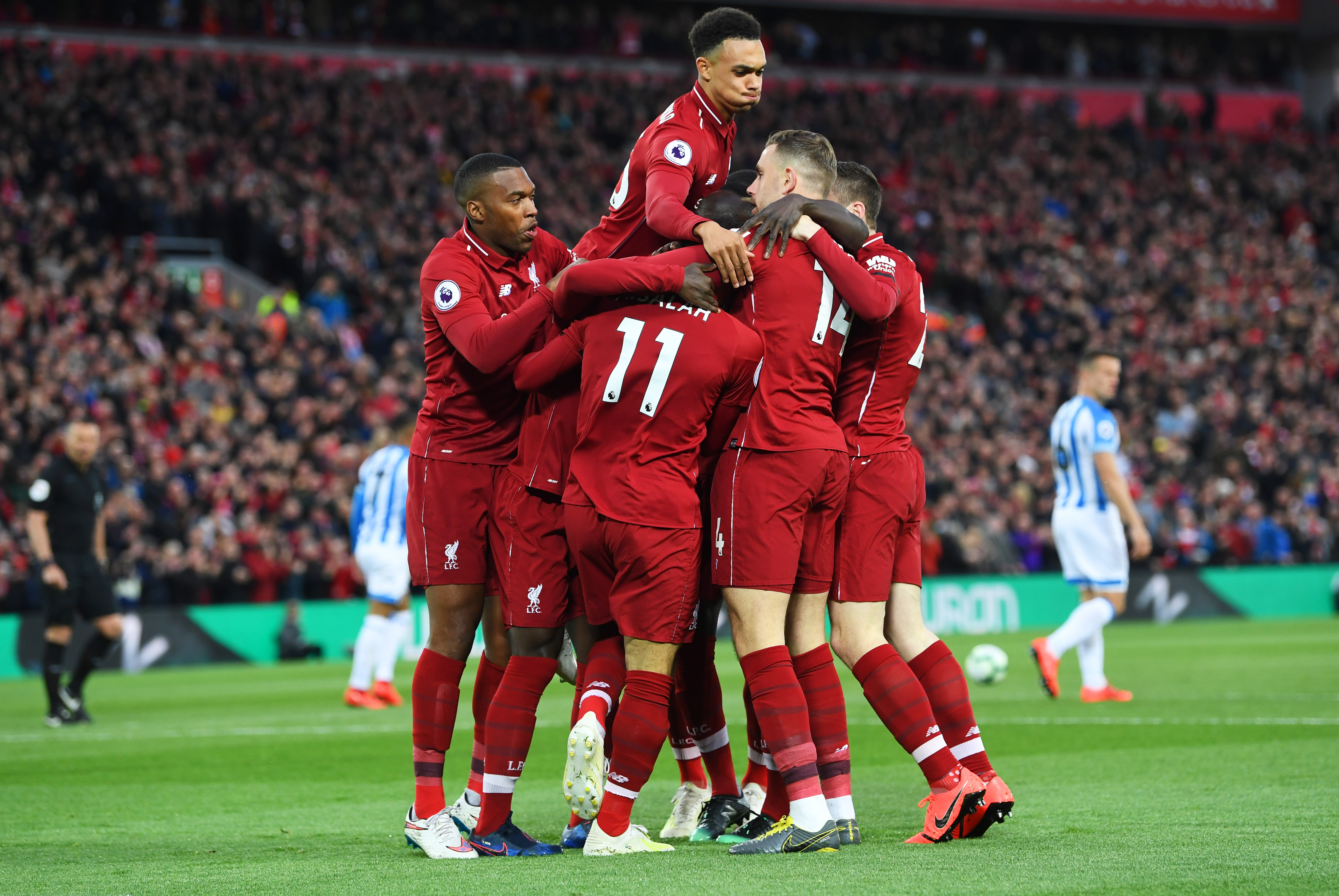LIVERPOOL, ENGLAND - APRIL 26:  Naby Keita of Liverpool (obscured) celebrates after scoring his team's first goal with team mates during the Premier League match between Liverpool FC and Huddersfield Town at Anfield on April 26, 2019 in Liverpool, United Kingdom. (Photo by Michael Regan/Getty Images)