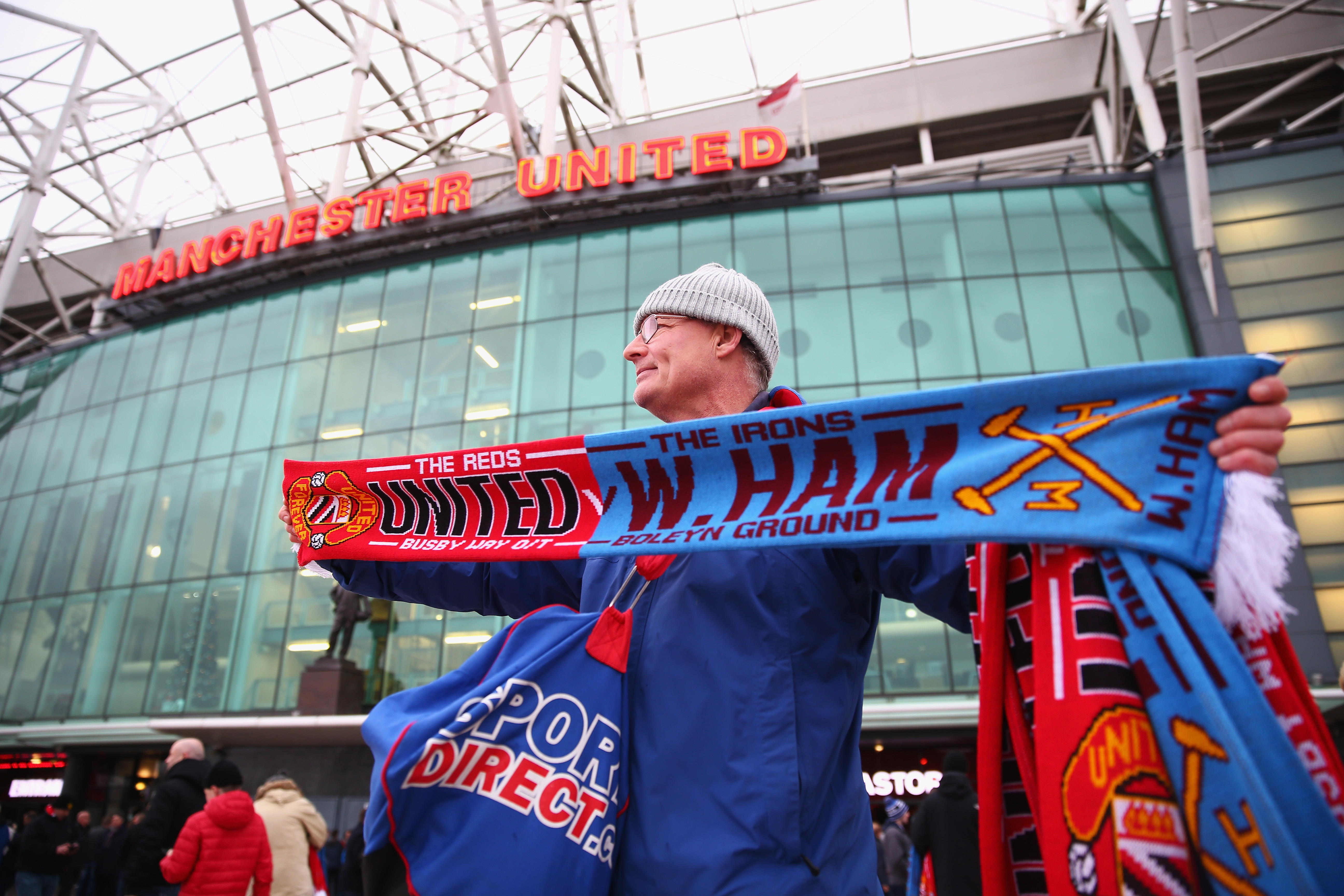 MANCHESTER, ENGLAND - DECEMBER 05:  Matchday scarves are sold outside the stadium prior to the Barclays Premier League match between Manchester United and West Ham United at Old Trafford on December 5, 2015 in Manchester, England.  (Photo by Clive Brunskill/Getty Images)