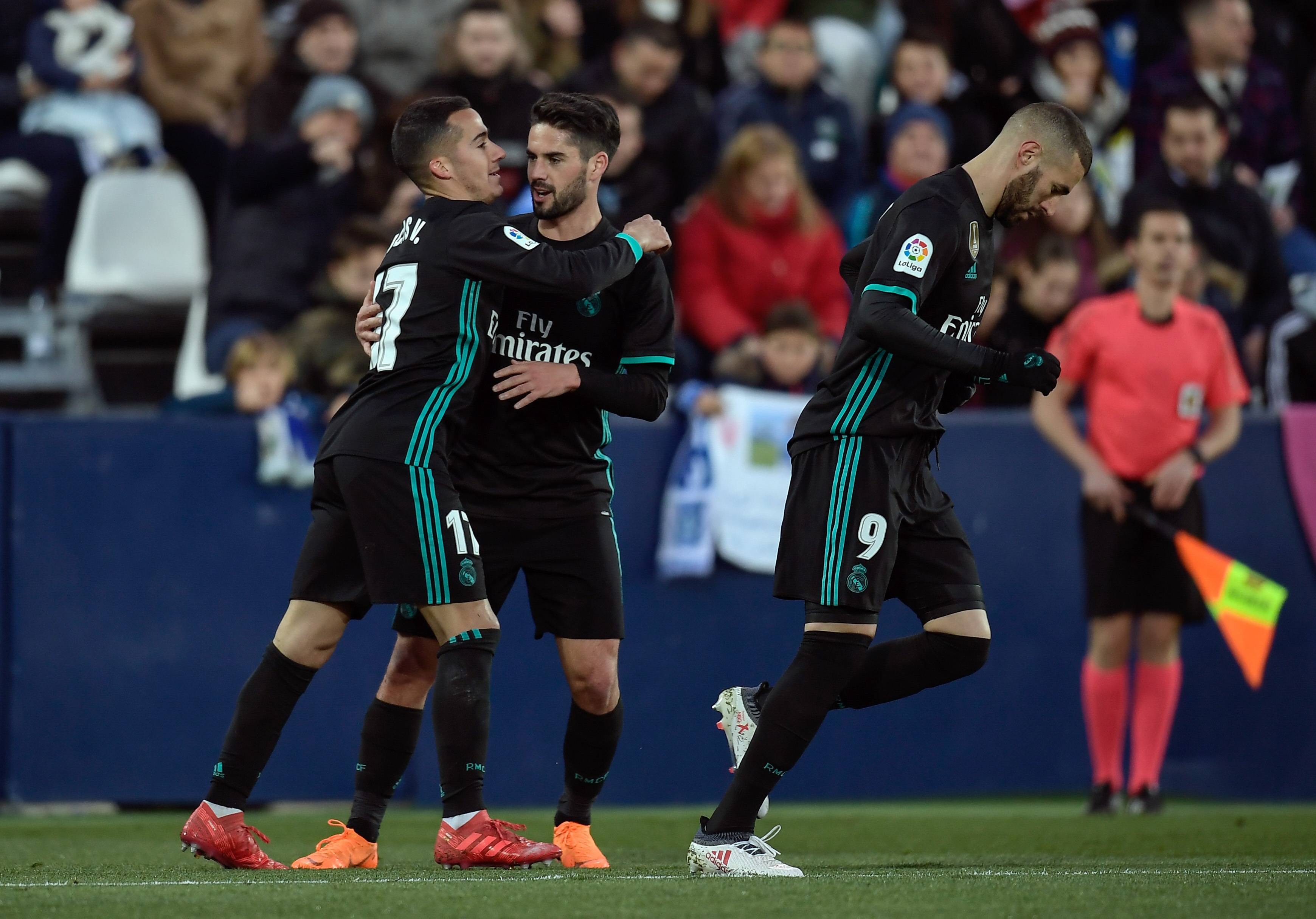 Real Madrid's from Spain forward Lucas Vazquez (L) celebrates woth Real Madrid's Spanish midfielder Isco and Real Madrid's French forward Karim Benzema after scoring during the Spanish league football match Club Deportivo Leganes SAD against Real Madrid CF at the Estadio Municipal Butarque in Leganes on the outskirts of Madrid on February 21, 2018. / AFP PHOTO / OSCAR DEL POZO        (Photo credit should read OSCAR DEL POZO/AFP/Getty Images)