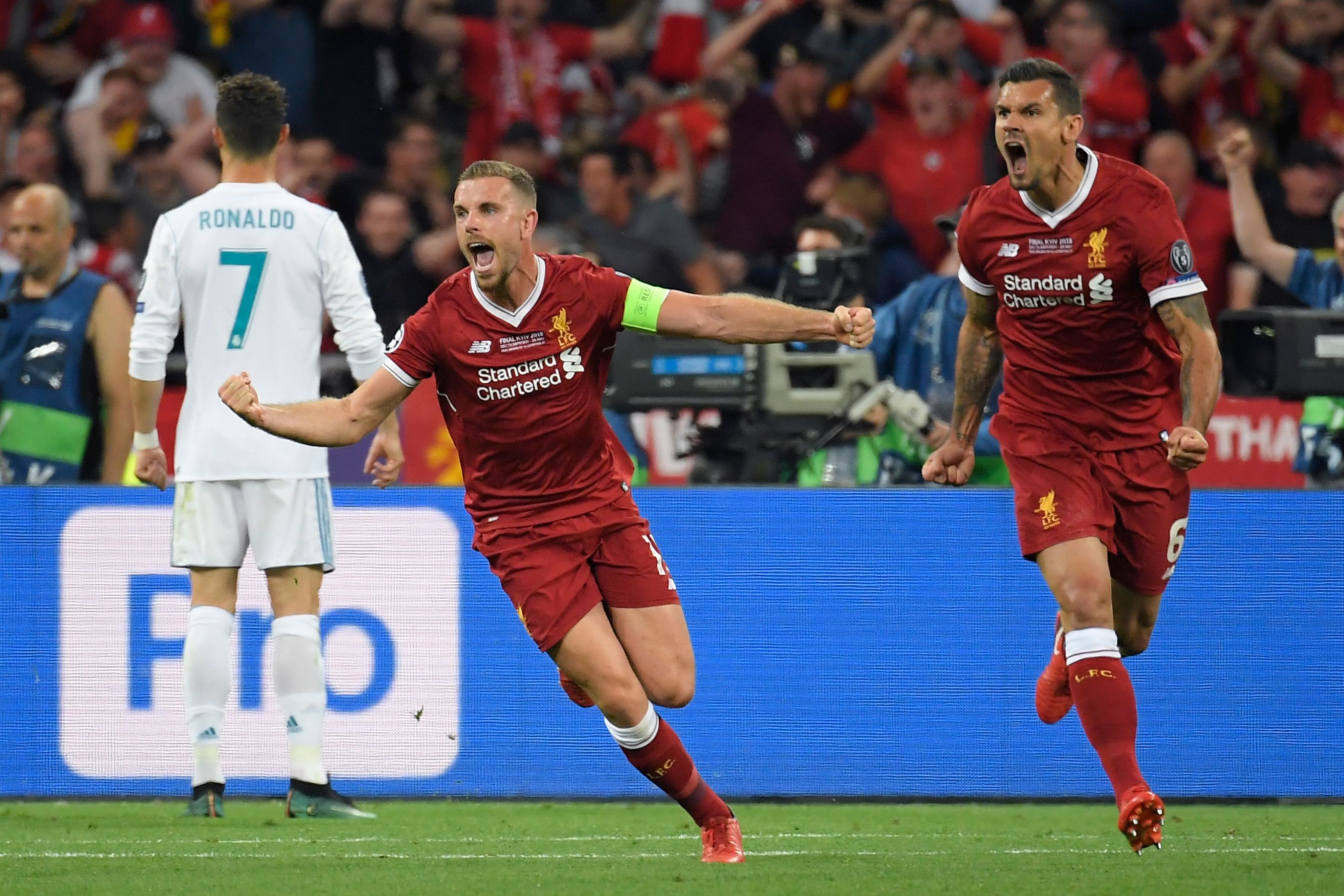 Liverpool's Liverpool's English midfielder Jordan Henderson (L) and Liverpool's Croatian defender Dejan Lovren celebrate after Liverpool's Senegalese midfielder Sadio Mane scored a goal during the UEFA Champions League final football match between Liverpool and Real Madrid at the Olympic Stadium in Kiev, Ukraine on May 26, 2018. (Photo by LLUIS GENE / AFP)        (Photo credit should read LLUIS GENE/AFP/Getty Images)