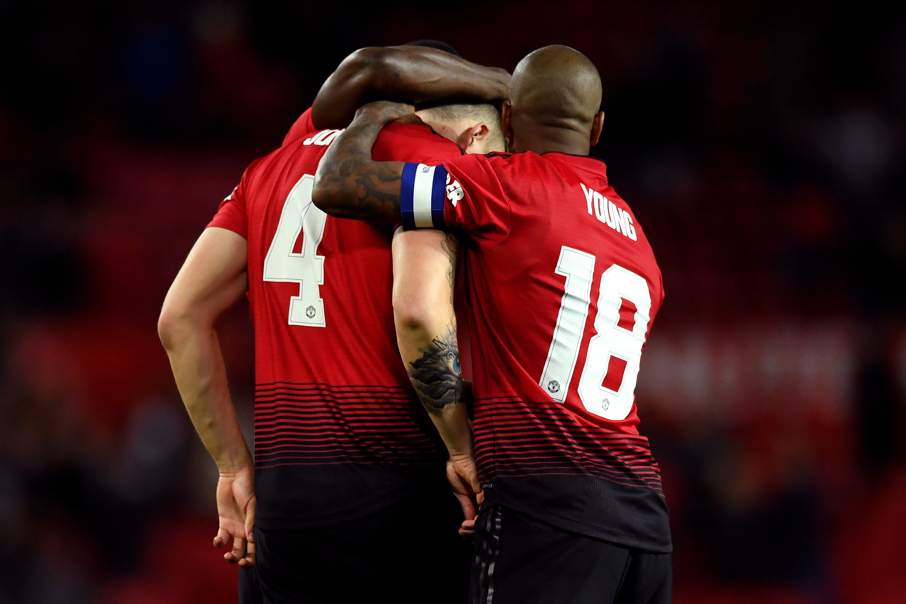 MANCHESTER, ENGLAND - SEPTEMBER 25:  Ashley Young of Manchester United consoles teammate Phil Jones of Manchester United after he misses his teams eight penalty, resulting in Derby County winning the penalty shoot out, and therefore the Carabao Cup Third Round match between Manchester United and Derby County at Old Trafford on September 25, 2018 in Manchester, England.  (Photo by Gareth Copley/Getty Images)