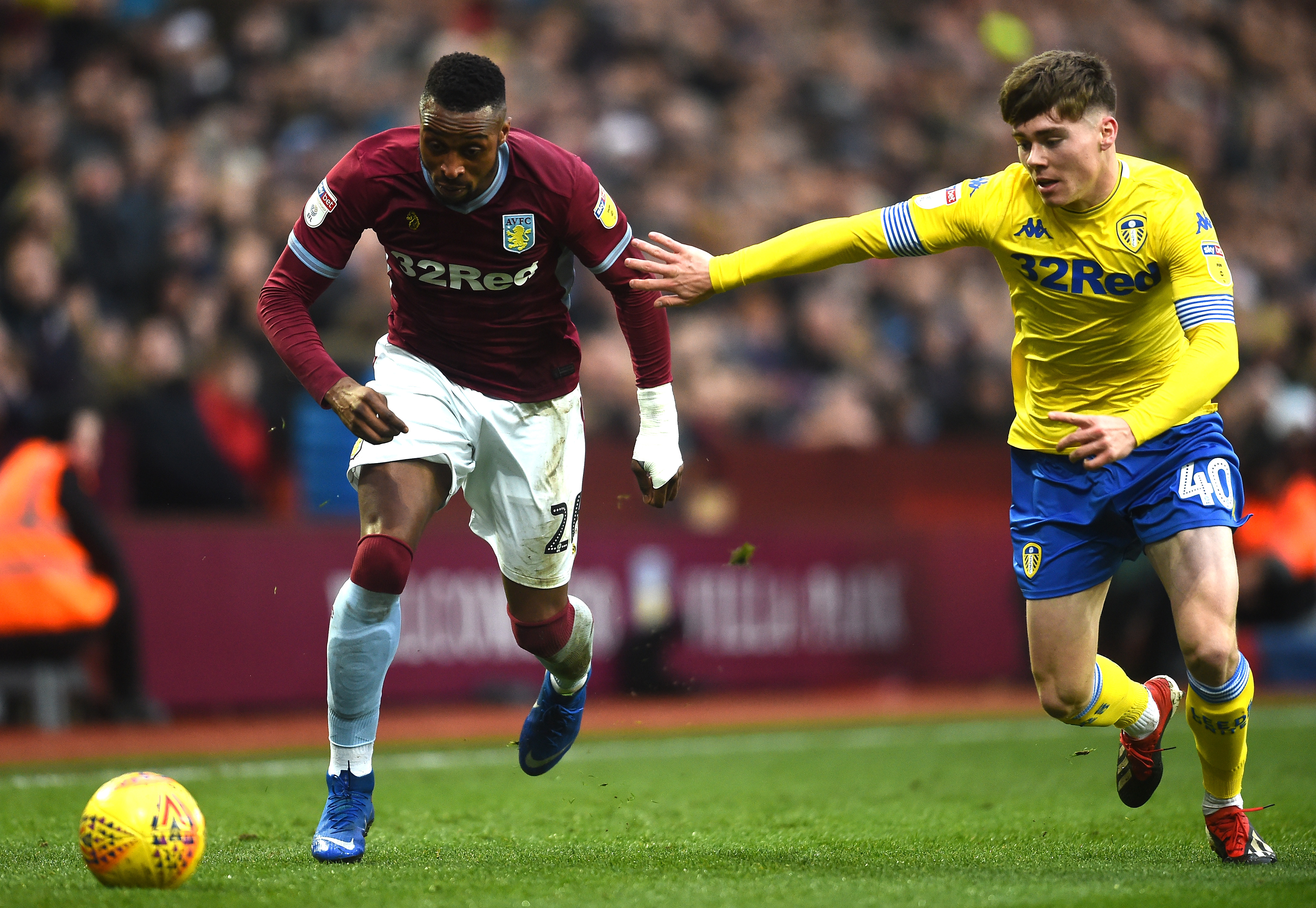 BIRMINGHAM, ENGLAND - DECEMBER 23:  Albert Adomah of Aston Villa and Leif Davis of Leeds United in action during the Sky Bet Championship match between Aston Villa and Leeds United at Villa Park on December 23, 2018 in Birmingham, England.  (Photo by Nathan Stirk/Getty Images)