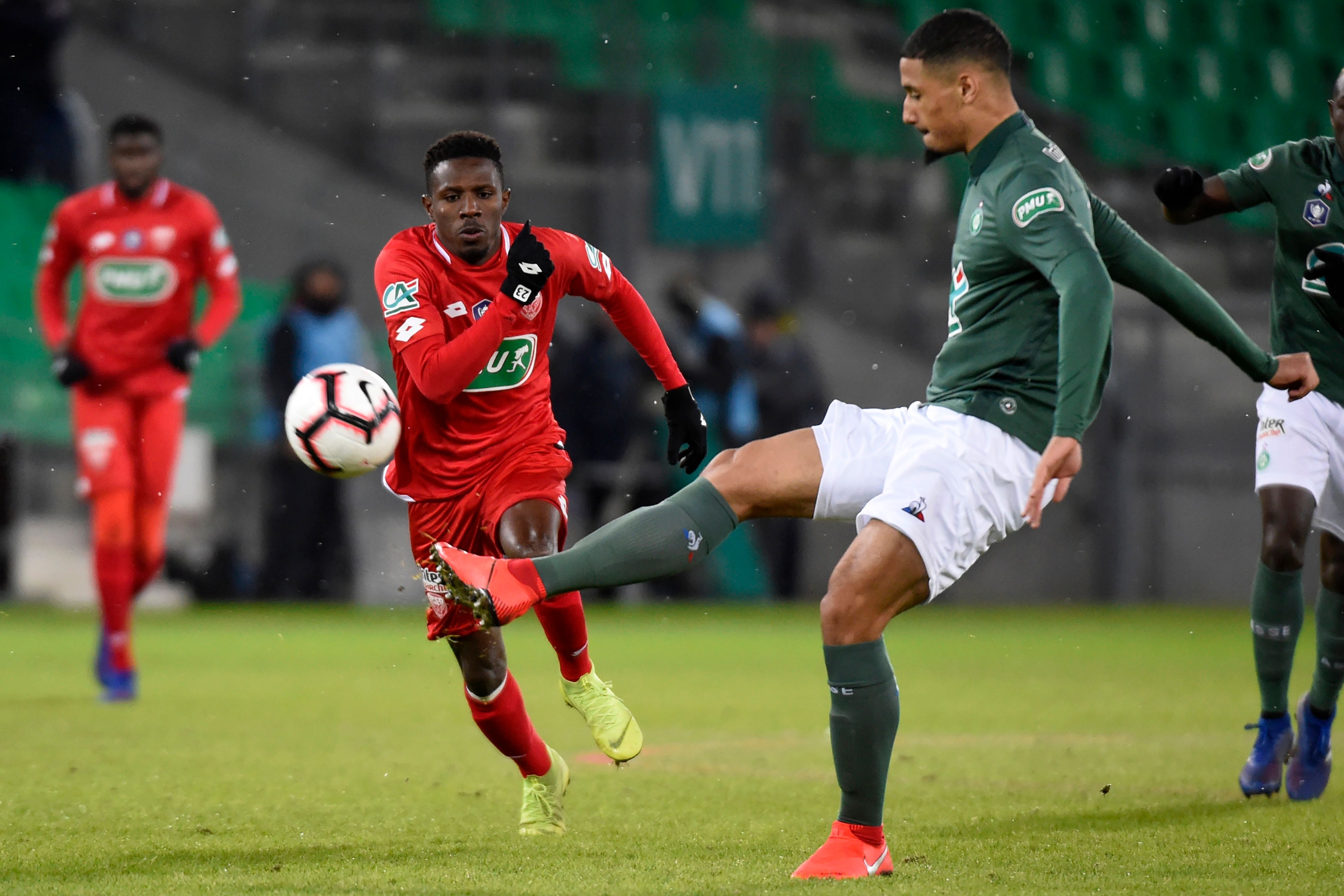 Dijon's Guinean midfielder Jules Keita (L) vies with Saint-Etienne's French forward William Saliba (R) during the French Cup round of 32 football match between Saint-Etienne (L1) and Dijon (L1), on January 23, 2019, at the Geoffroy Guichard Stadium in Saint-Etienne, central France. (Photo by JEAN-PHILIPPE KSIAZEK / AFP)        (Photo credit should read JEAN-PHILIPPE KSIAZEK/AFP/Getty Images)