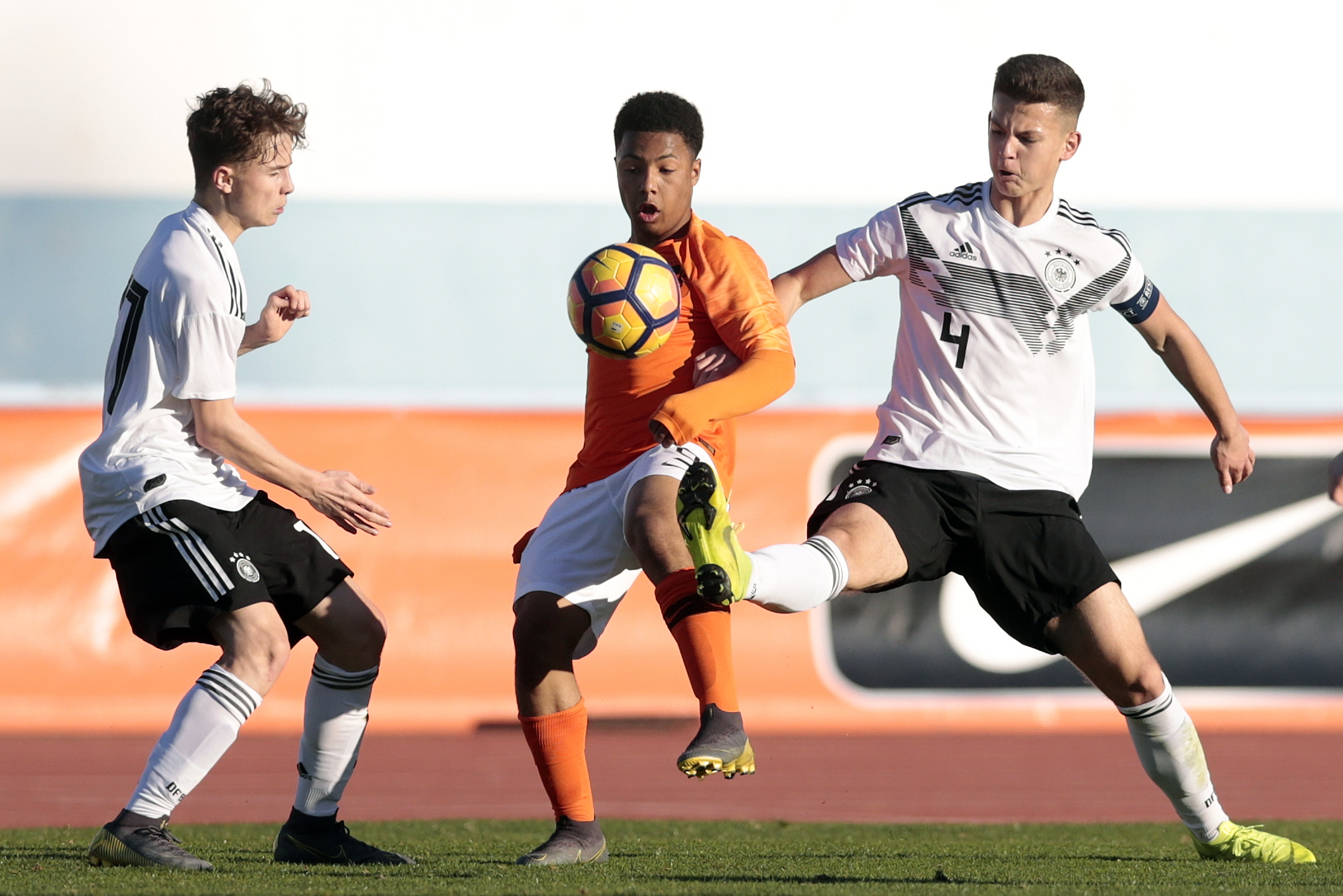 VILA REAL SANTO ANTONIO, PORTUGAL - FEBRUARY 7: Mehmet Ibrahimi (L) and Arbnor Alit (R) of Germany U16 challenges Dillon Hoogewerf (C) of Netherlands U16 during UEFA Development Tournament match between U16 Netherlands and U16 Germany at VRSA Stadium on February 7, 2019 in Vila Real Santo Antonio, Portugal. (Photo by Ricardo Nascimento/Getty Images)