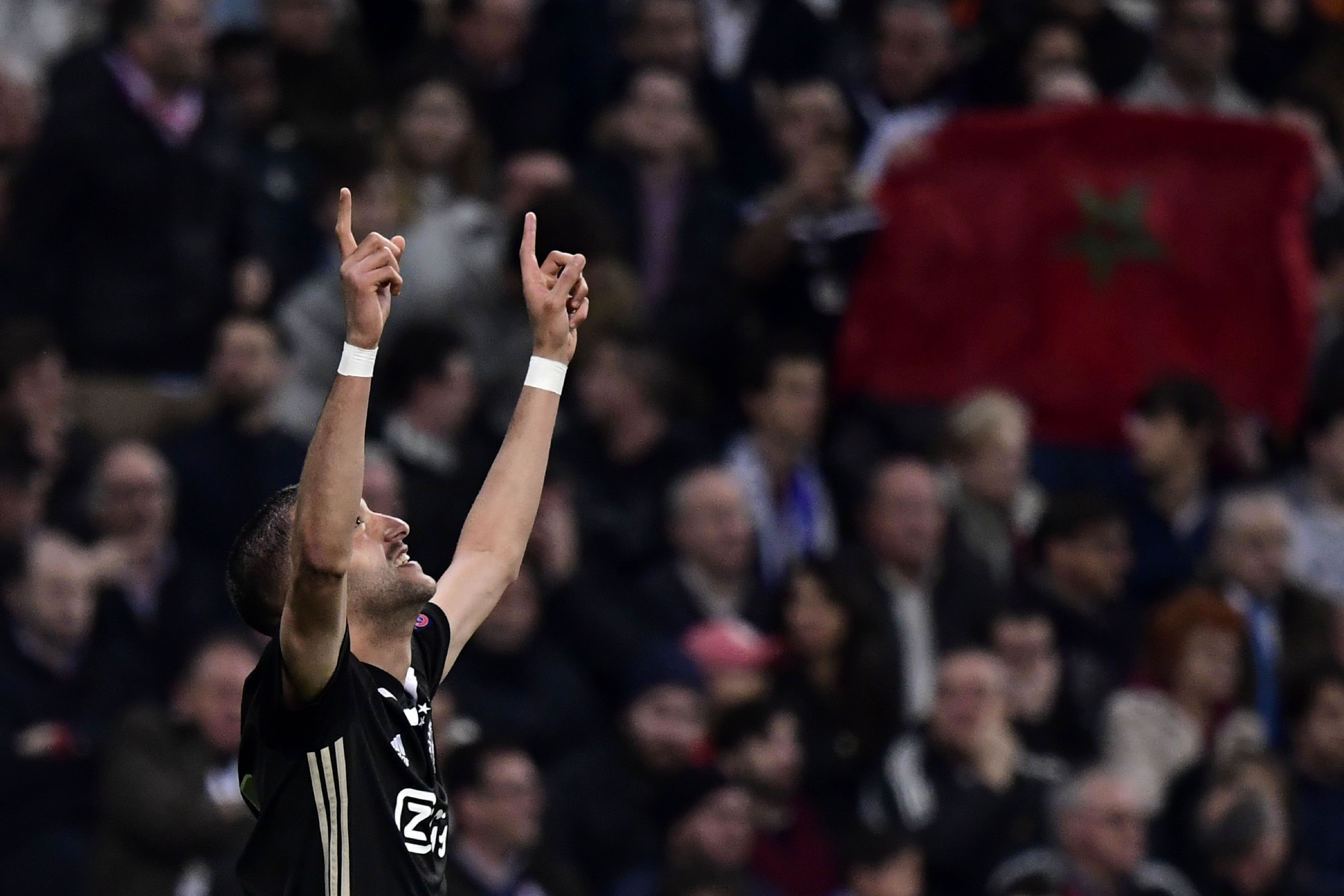Ajax's Moroccan midfielder Hakim Ziyech celebrates after scoring a goal against Real Madrid's Belgian goalkeeper Thibaut Courtois (R) during the UEFA Champions League round of 16 second leg football match between Real Madrid CF and Ajax at the Santiago Bernabeu stadium in Madrid on March 5, 2019. (Photo by JAVIER SORIANO / AFP)        (Photo credit should read JAVIER SORIANO/AFP/Getty Images)