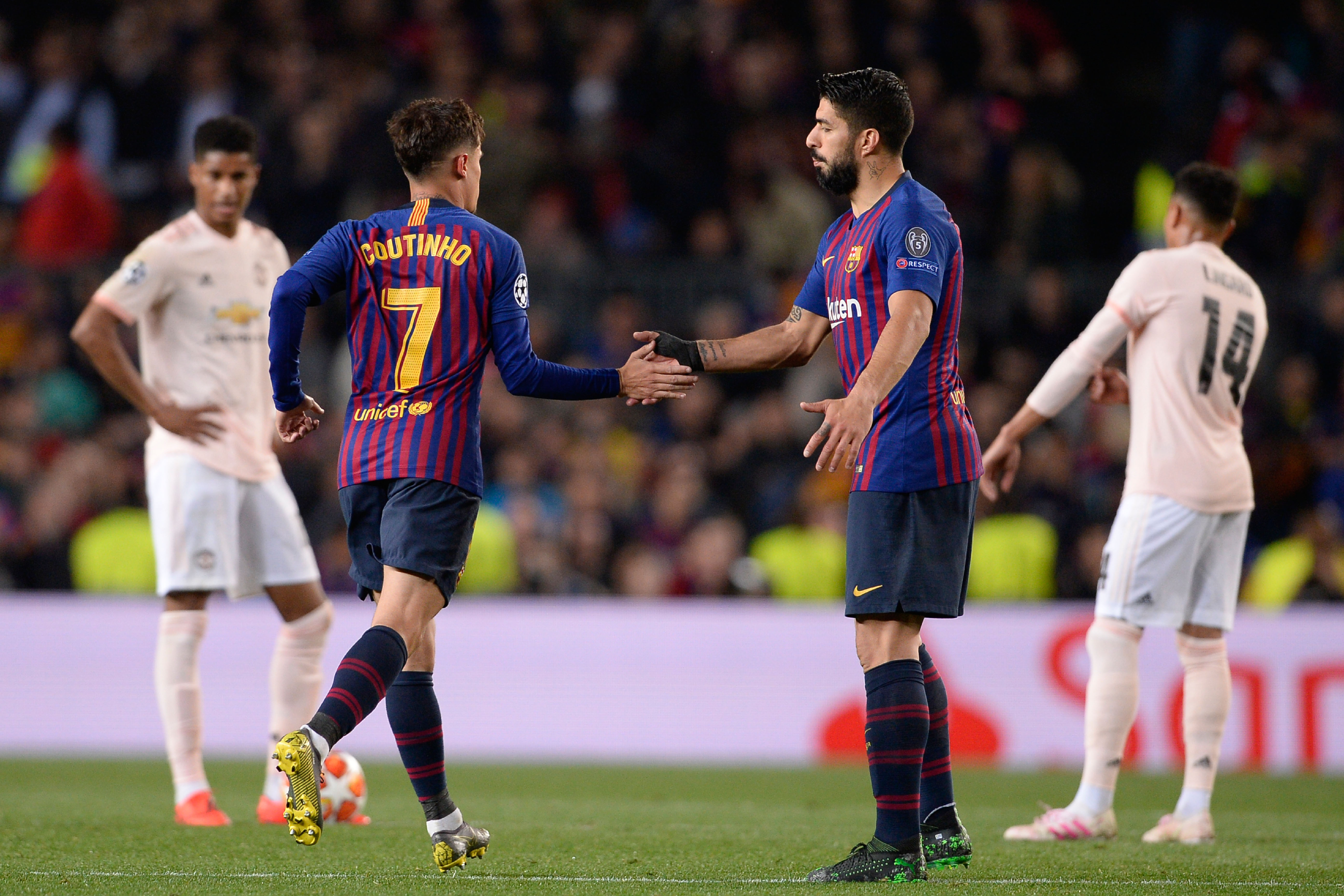 Barcelona's Brazilian midfielder Philippe Coutinho (L) celebrates with Barcelona's Uruguayan forward Luis Suarez after scoring during the UEFA Champions League quarter-final second leg football match between Barcelona and Manchester United at the Camp Nou stadium in Barcelona on April 16, 2019. (Photo by PAU BARRENA / AFP)        (Photo credit should read PAU BARRENA/AFP/Getty Images)