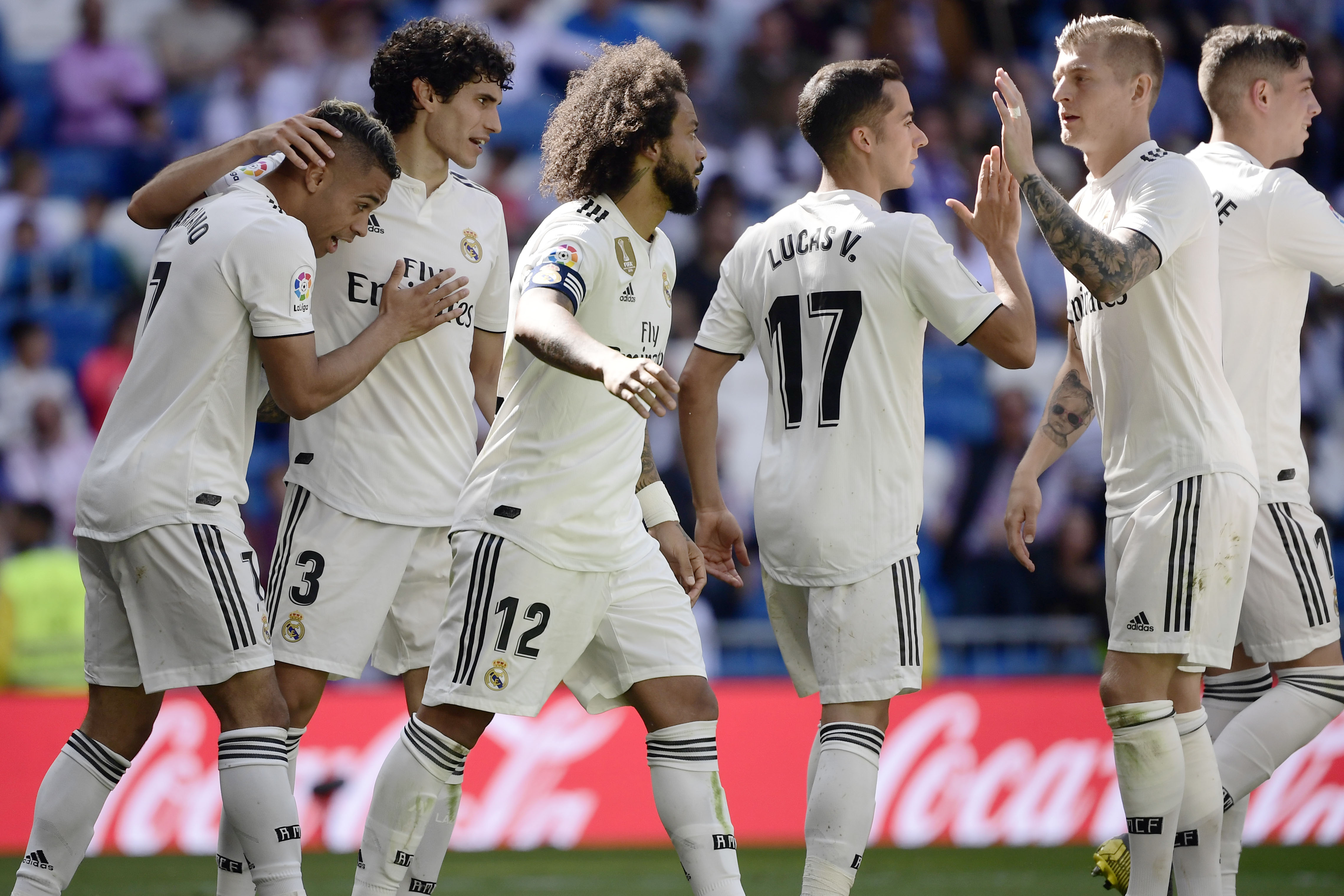 Real Madrid's Spanish-Dominican forward Mariano (L) celebrates his second goal with teammates during the Spanish league football match between Real Madrid CF and Villarreal CF at the Santiago Bernabeu stadium in Madrid on May 5, 2019. (Photo by JAVIER SORIANO / AFP)        (Photo credit should read JAVIER SORIANO/AFP/Getty Images)
