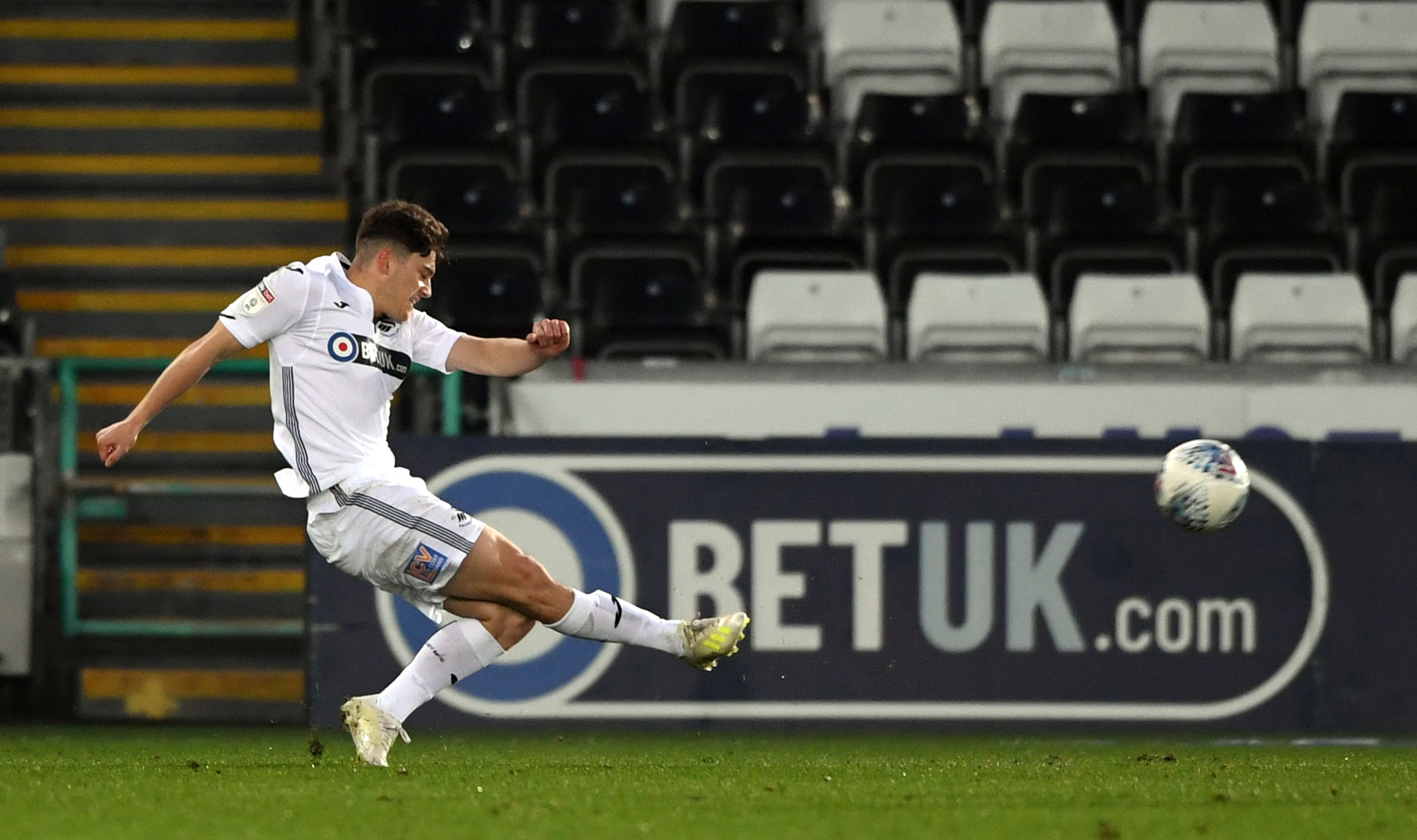 SWANSEA, WALES - APRIL 09: Swansea player Daniel James shoots to score the opening goal during the Sky Bet Championship match between Swansea City and Stoke City at Liberty Stadium on April 09, 2019 in Swansea, Wales. (Photo by Stu Forster/Getty Images)