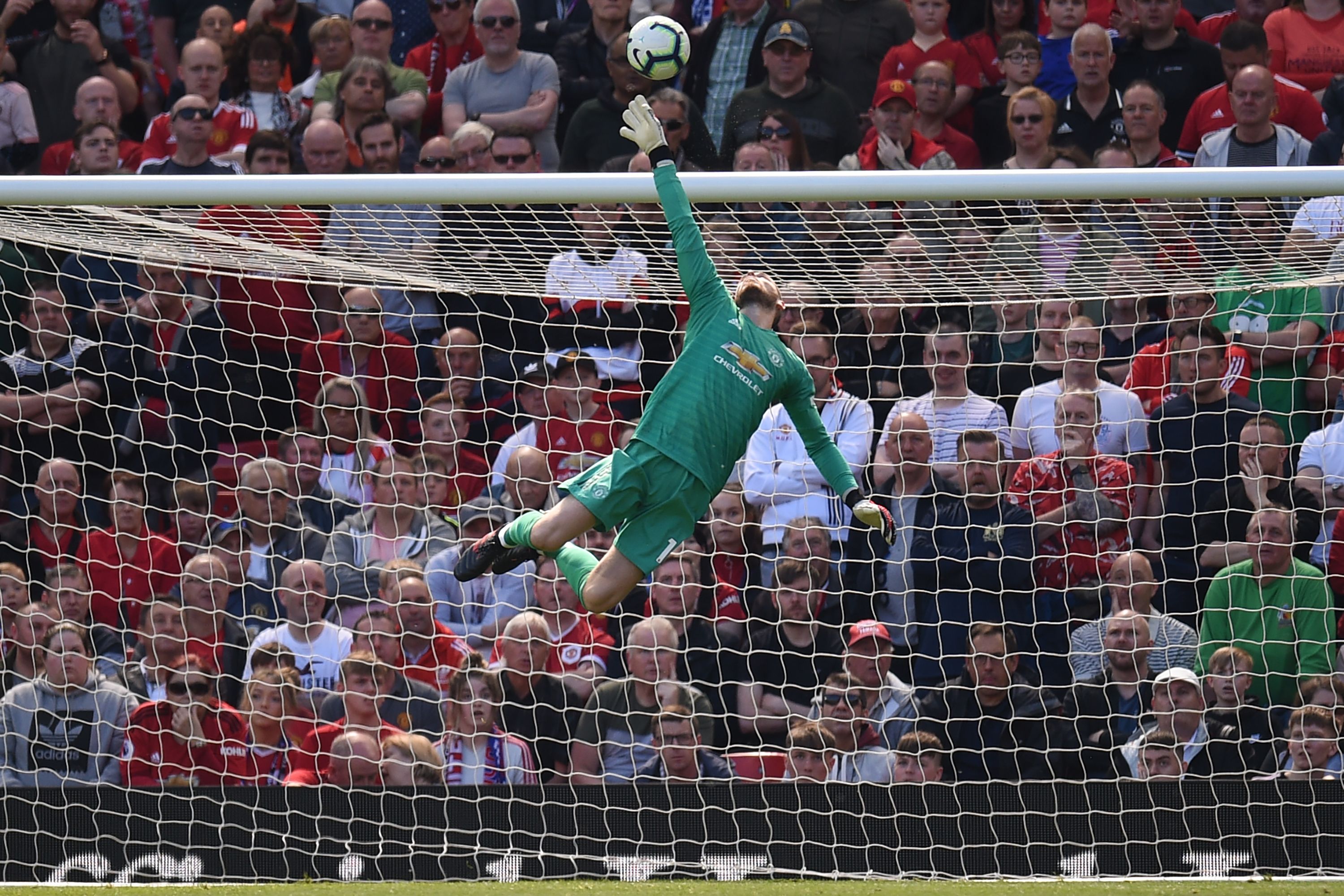 TOPSHOT - Manchester United's Spanish goalkeeper David de Gea makes a save during the English Premier League football match between Manchester United and Cardiff City at Old Trafford in Manchester, north west England, on May 12, 2019. (Photo by Oli SCARFF / AFP) / RESTRICTED TO EDITORIAL USE. No use with unauthorized audio, video, data, fixture lists, club/league logos or 'live' services. Online in-match use limited to 120 images. An additional 40 images may be used in extra time. No video emulation. Social media in-match use limited to 120 images. An additional 40 images may be used in extra time. No use in betting publications, games or single club/league/player publications. /         (Photo credit should read OLI SCARFF/AFP/Getty Images)