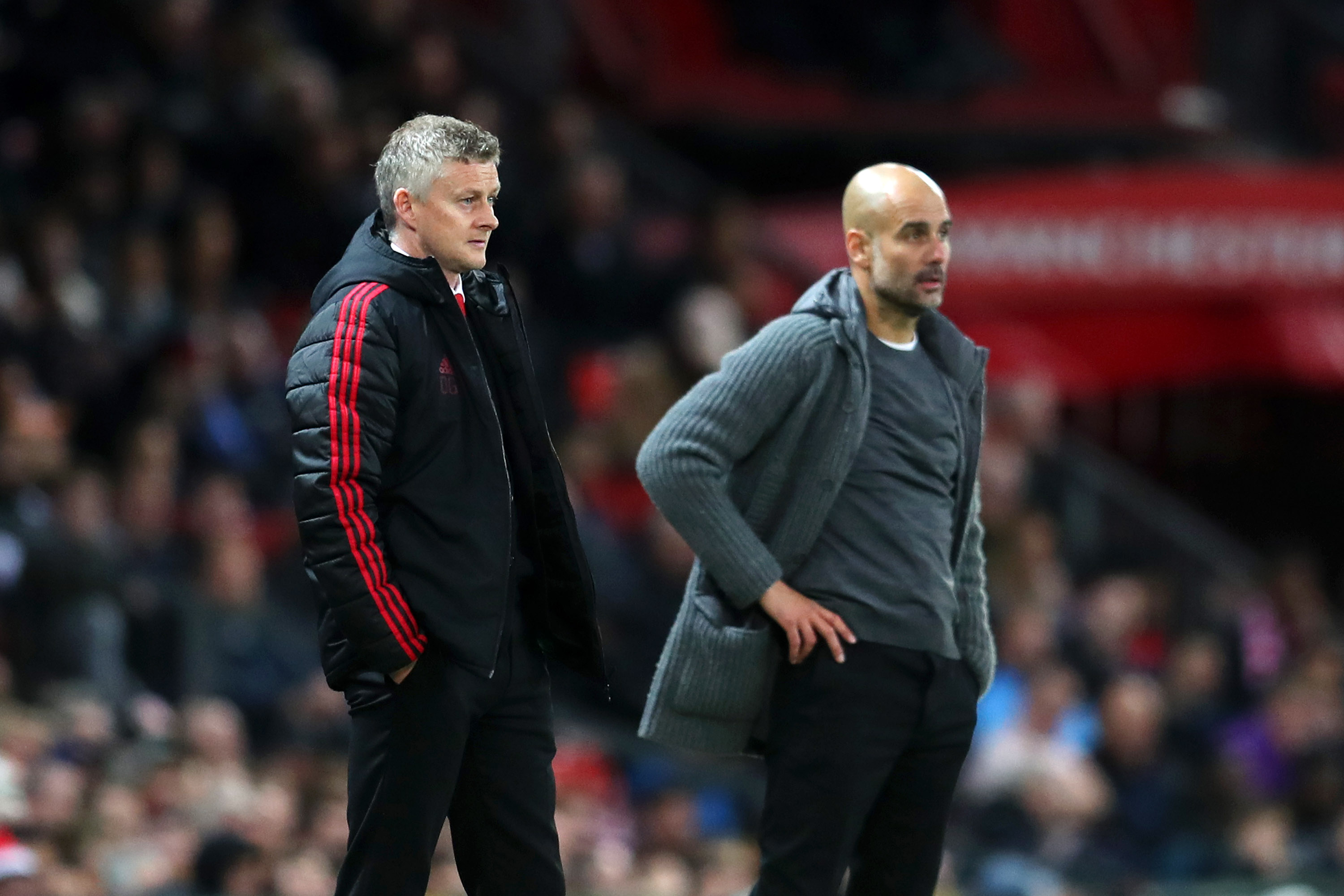 MANCHESTER, ENGLAND - APRIL 24:  Ole Gunnar Solskjaer, Manager of Manchester United and Josep Guardiola, Manager of Manchester City look on during the Premier League match between Manchester United and Manchester City at Old Trafford on April 24, 2019 in Manchester, United Kingdom. (Photo by Catherine Ivill/Getty Images)