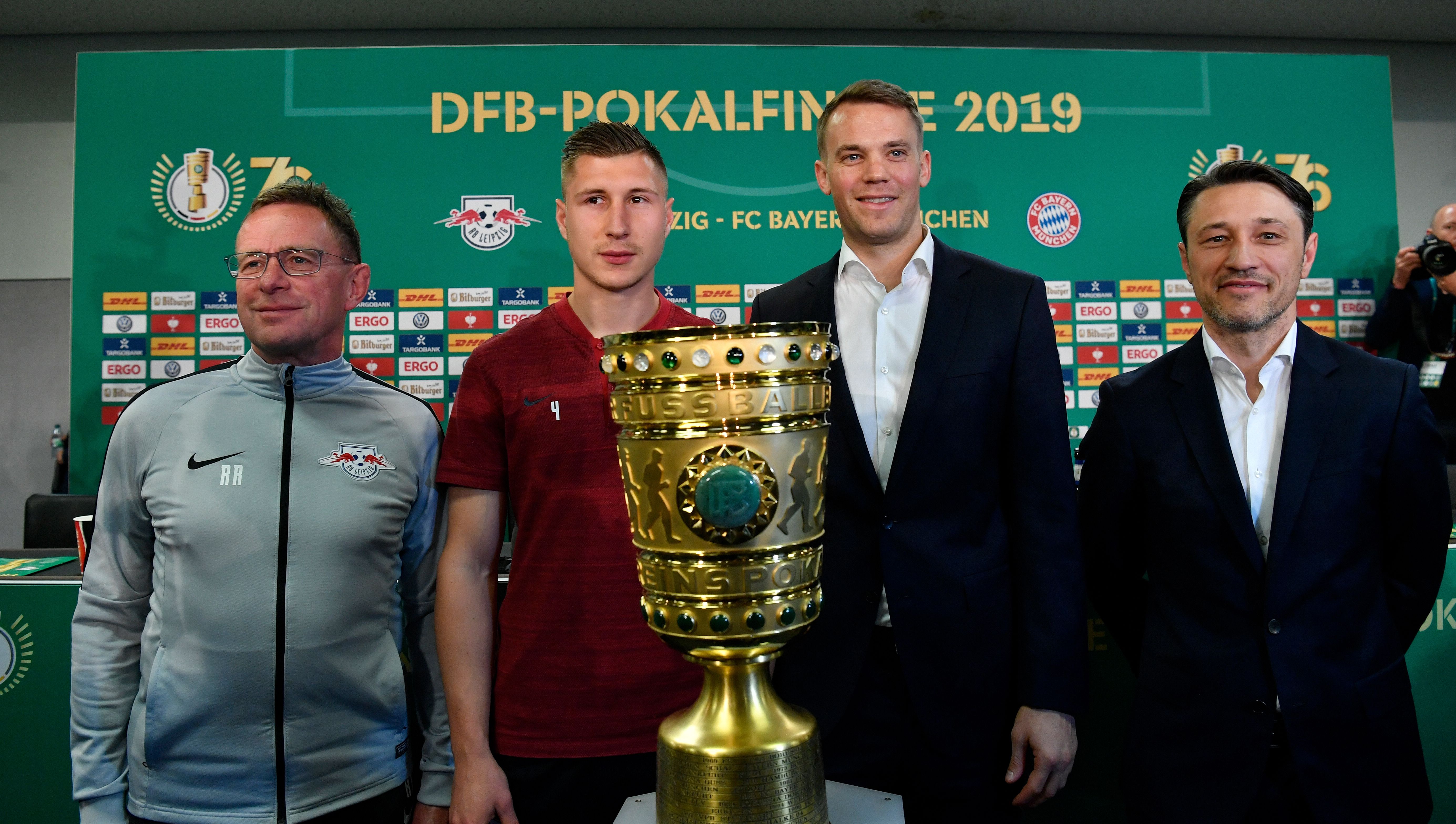 (L-R) Leipzig's German headcoach Ralf Rangnick, Leipzig's German defender Willi Orban, Bayern Munich's German goalkeeper Manuel Neuerand Bayern Munich's Croatian headcoach Niko Kovac pose with the trophy after a press conference on the eve of the German Cup (DFB Pokal) Final football match RB Leipzig v FC Bayern Munich at the Olympic Stadium in Berlin on May 24, 2019. (Photo by John MACDOUGALL / AFP)        (Photo credit should read JOHN MACDOUGALL/AFP/Getty Images)