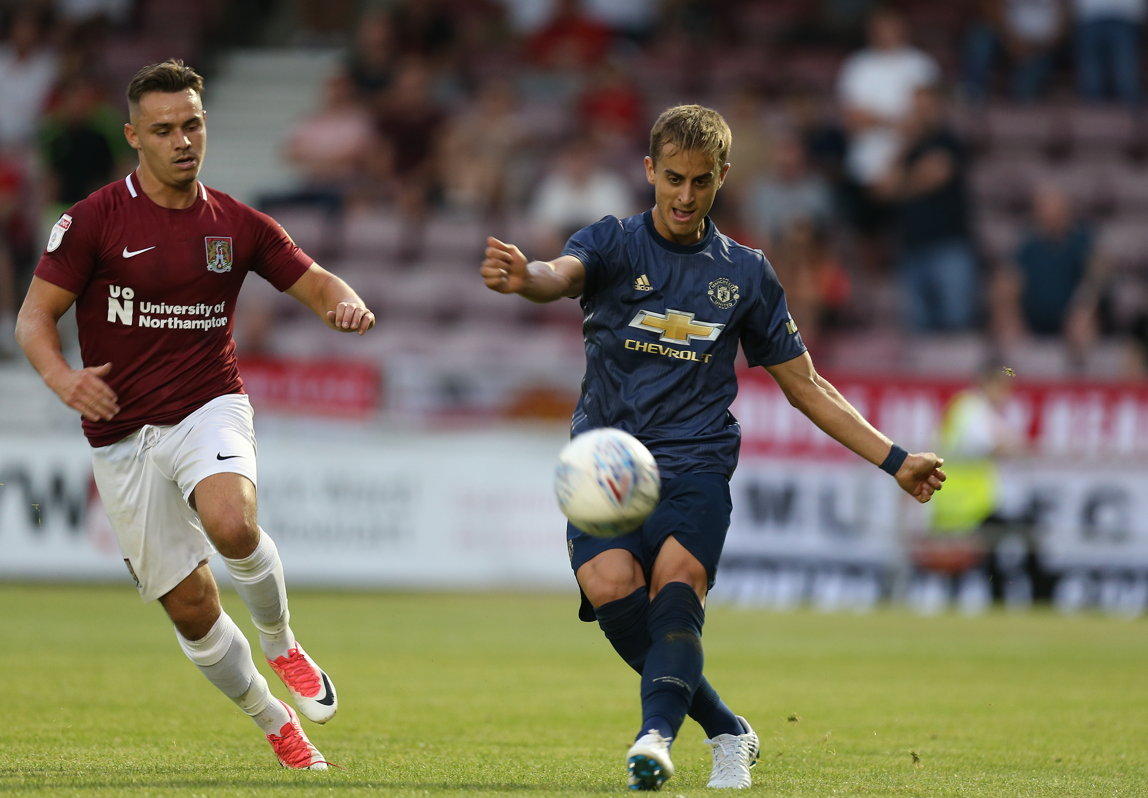 NORTHAMPTON, ENGLAND - JULY 27:  Luca Ercolani of Manchester United plays the ball watched by Billy Waters of Northampton Town during the Pre-Season Friendly match between Northampton Town and Manchester United XI at PTS Academy Stadium on July 27, 2018 in Northampton, England. (Photo by Pete Norton/Getty Images)