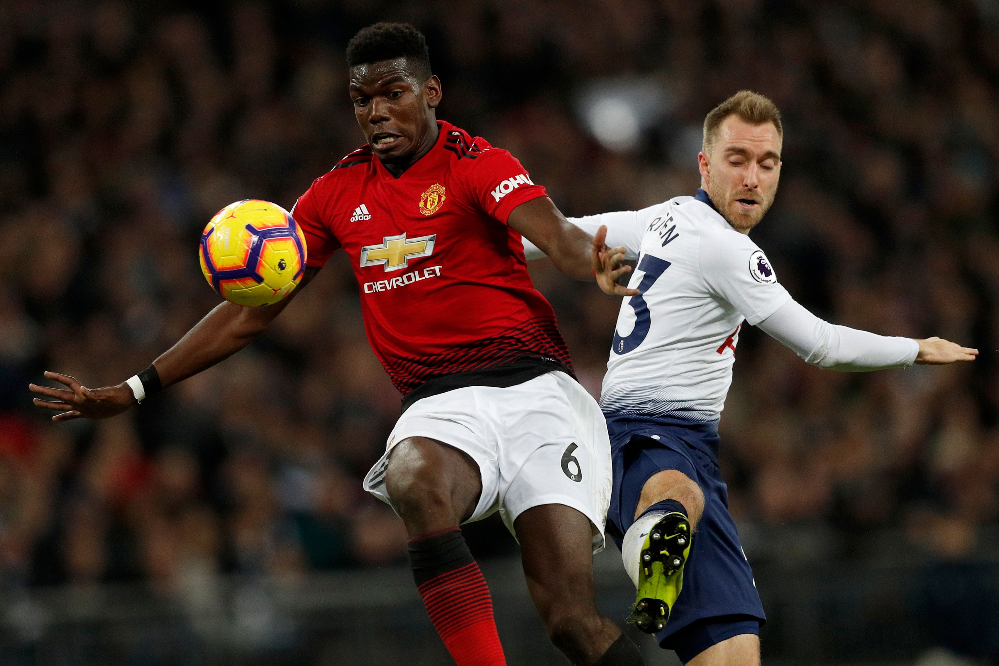 Manchester United's French midfielder Paul Pogba (L) vies with Tottenham Hotspur's Danish midfielder Christian Eriksen (R) during the English Premier League football match between Tottenham Hotspur and Manchester United at Wembley Stadium in London, on January 13, 2019. (Photo by Adrian DENNIS / AFP) / RESTRICTED TO EDITORIAL USE. No use with unauthorized audio, video, data, fixture lists, club/league logos or 'live' services. Online in-match use limited to 120 images. An additional 40 images may be used in extra time. No video emulation. Social media in-match use limited to 120 images. An additional 40 images may be used in extra time. No use in betting publications, games or single club/league/player publications. /         (Photo credit should read ADRIAN DENNIS/AFP/Getty Images)