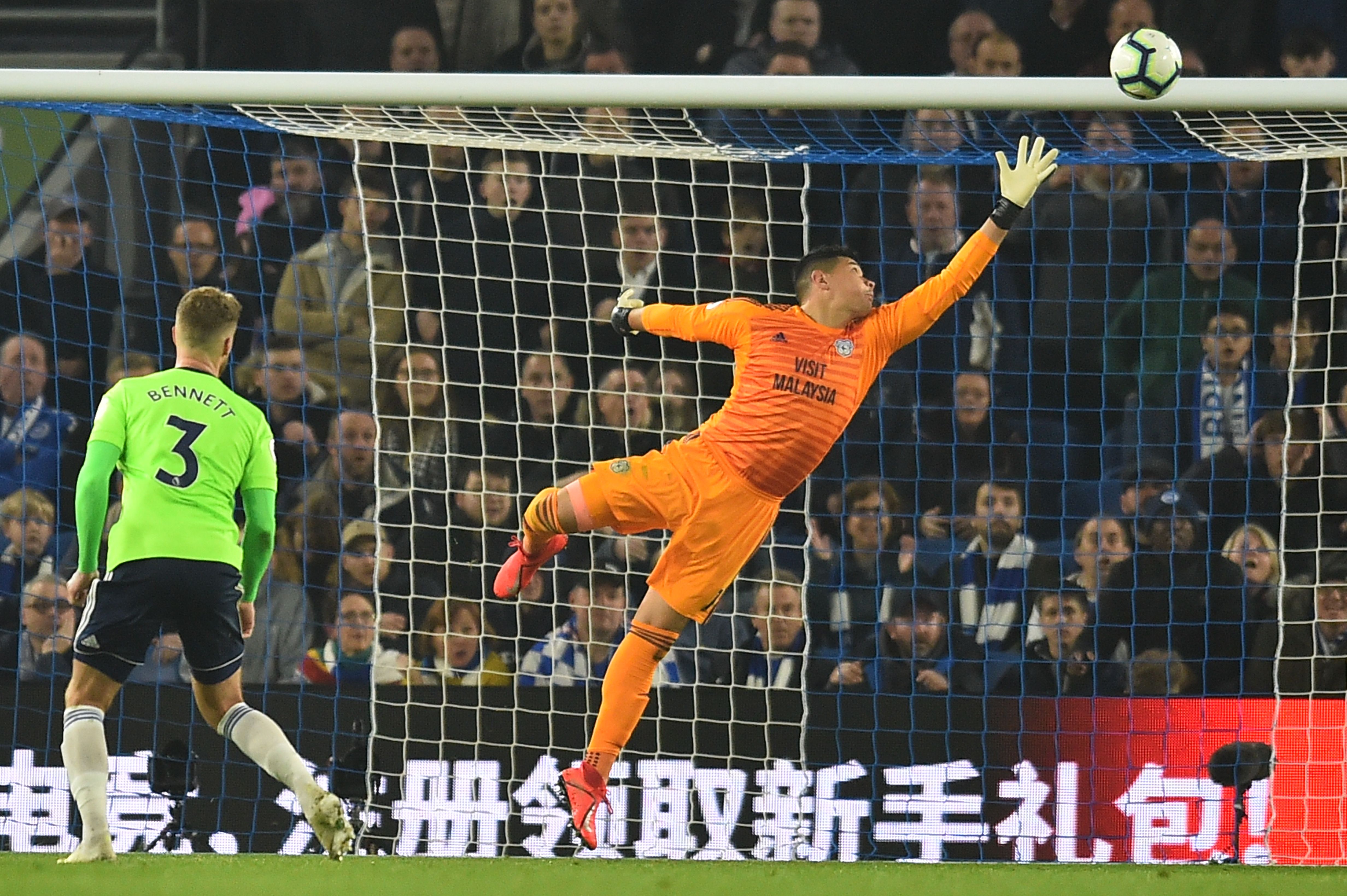 Cardiff City's English-born Filipino goalkeeper Neil Etheridge (R) reaches for a shot that goes over the bar during the English Premier League football match between Brighton and Hove Albion and Cardiff City at the American Express Community Stadium in Brighton, southern England on April 19, 2019. (Photo by Glyn KIRK / AFP) / RESTRICTED TO EDITORIAL USE. No use with unauthorized audio, video, data, fixture lists, club/league logos or 'live' services. Online in-match use limited to 120 images. An additional 40 images may be used in extra time. No video emulation. Social media in-match use limited to 120 images. An additional 40 images may be used in extra time. No use in betting publications, games or single club/league/player publications. /         (Photo credit should read GLYN KIRK/AFP/Getty Images)
