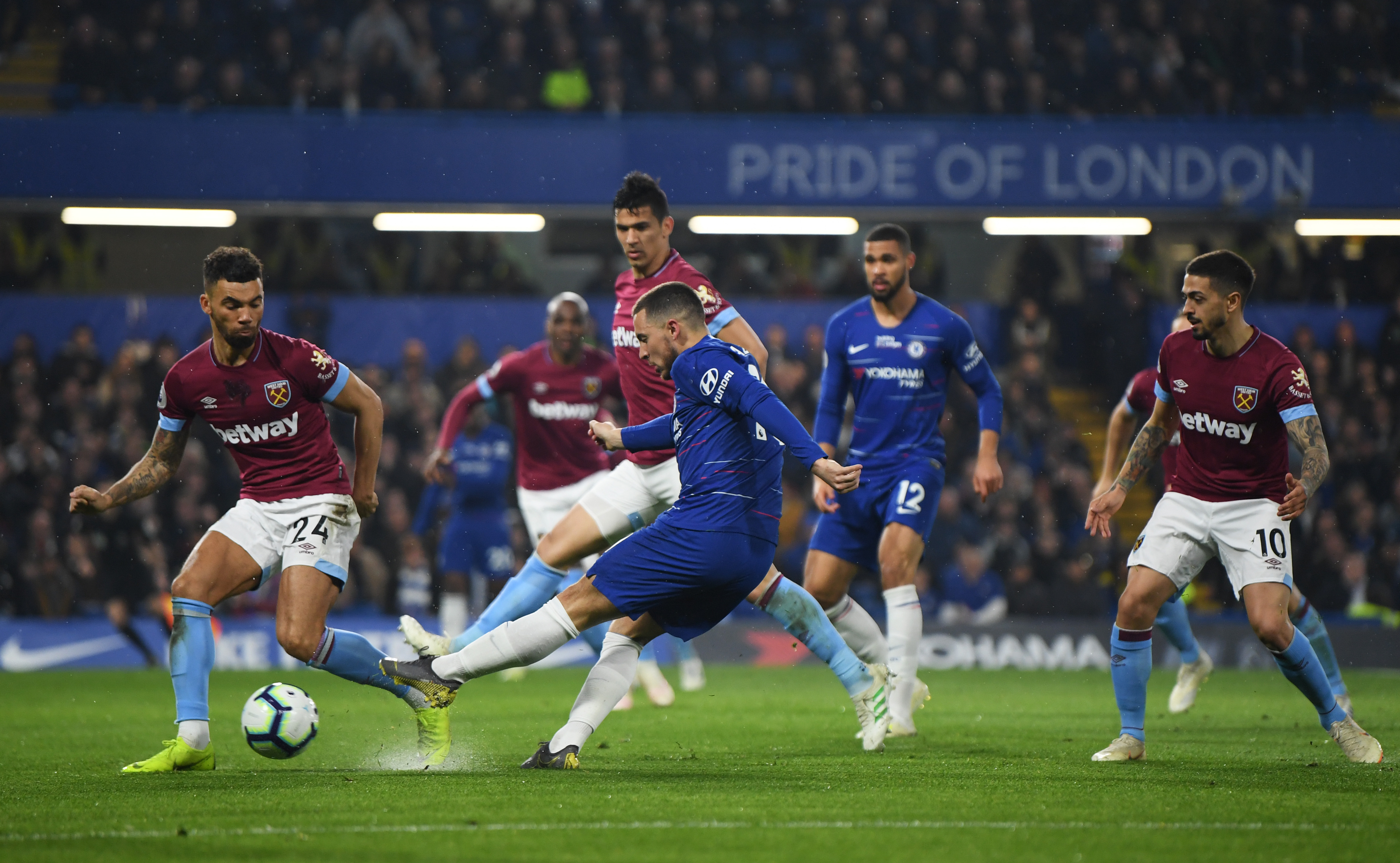 LONDON, ENGLAND - APRIL 08:  Eden Hazard of Chelsea shoots past Ryan Fredericks of West Ham United during the Premier League match between Chelsea FC and West Ham United at Stamford Bridge on April 08, 2019 in London, United Kingdom. (Photo by Mike Hewitt/Getty Images)