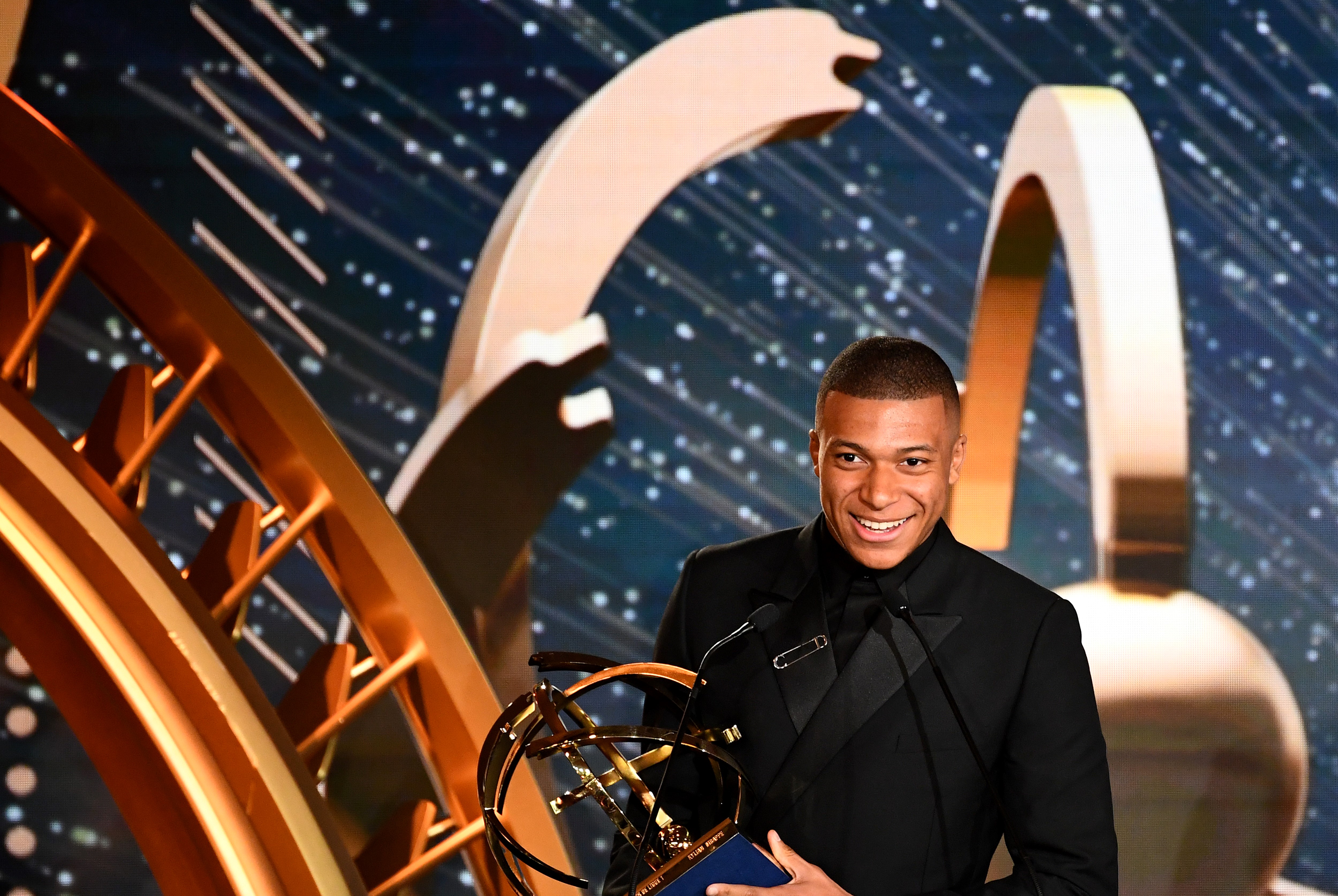 TOPSHOT - Paris Saint-Germain's French forward Kylian MBappe reacts after receiving the Best Ligue 1 player award , on May 19, 2019 in Paris, during the 28th edition of the UNFP (French National Professional Football players Union) trophy ceremony. (Photo by FRANCK FIFE / AFP)        (Photo credit should read FRANCK FIFE/AFP/Getty Images)