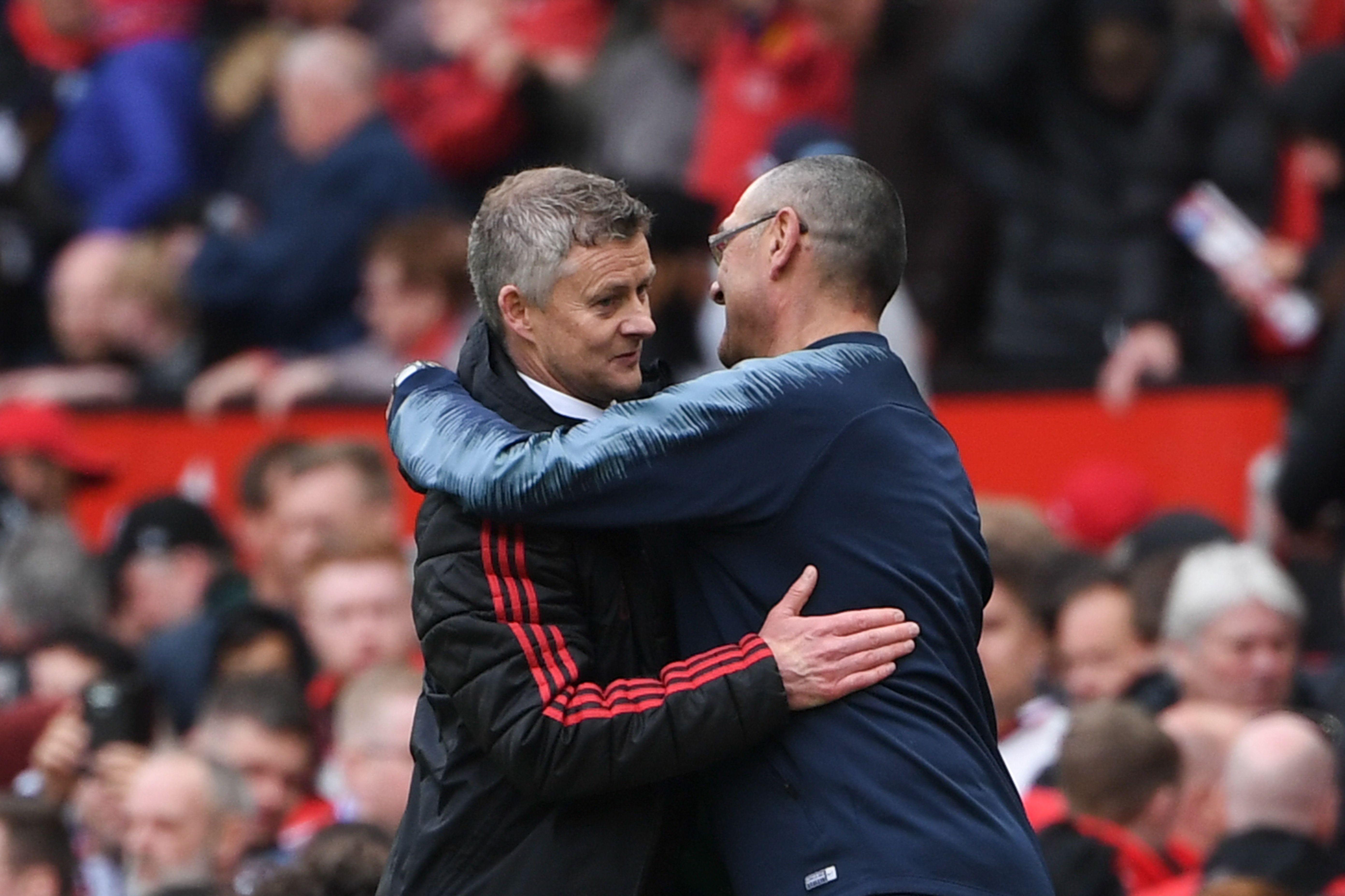 Manchester United's Norwegian manager Ole Gunnar Solskjaer (L) embraces Chelsea's Italian head coach Maurizio Sarri (R) at the end of the English Premier League football match between Manchester United and Chelsea at Old Trafford in Manchester, north west England, on April 28, 2019. (Photo by Paul ELLIS / AFP) / RESTRICTED TO EDITORIAL USE. No use with unauthorized audio, video, data, fixture lists, club/league logos or 'live' services. Online in-match use limited to 120 images. An additional 40 images may be used in extra time. No video emulation. Social media in-match use limited to 120 images. An additional 40 images may be used in extra time. No use in betting publications, games or single club/league/player publications. /         (Photo credit should read PAUL ELLIS/AFP/Getty Images)
