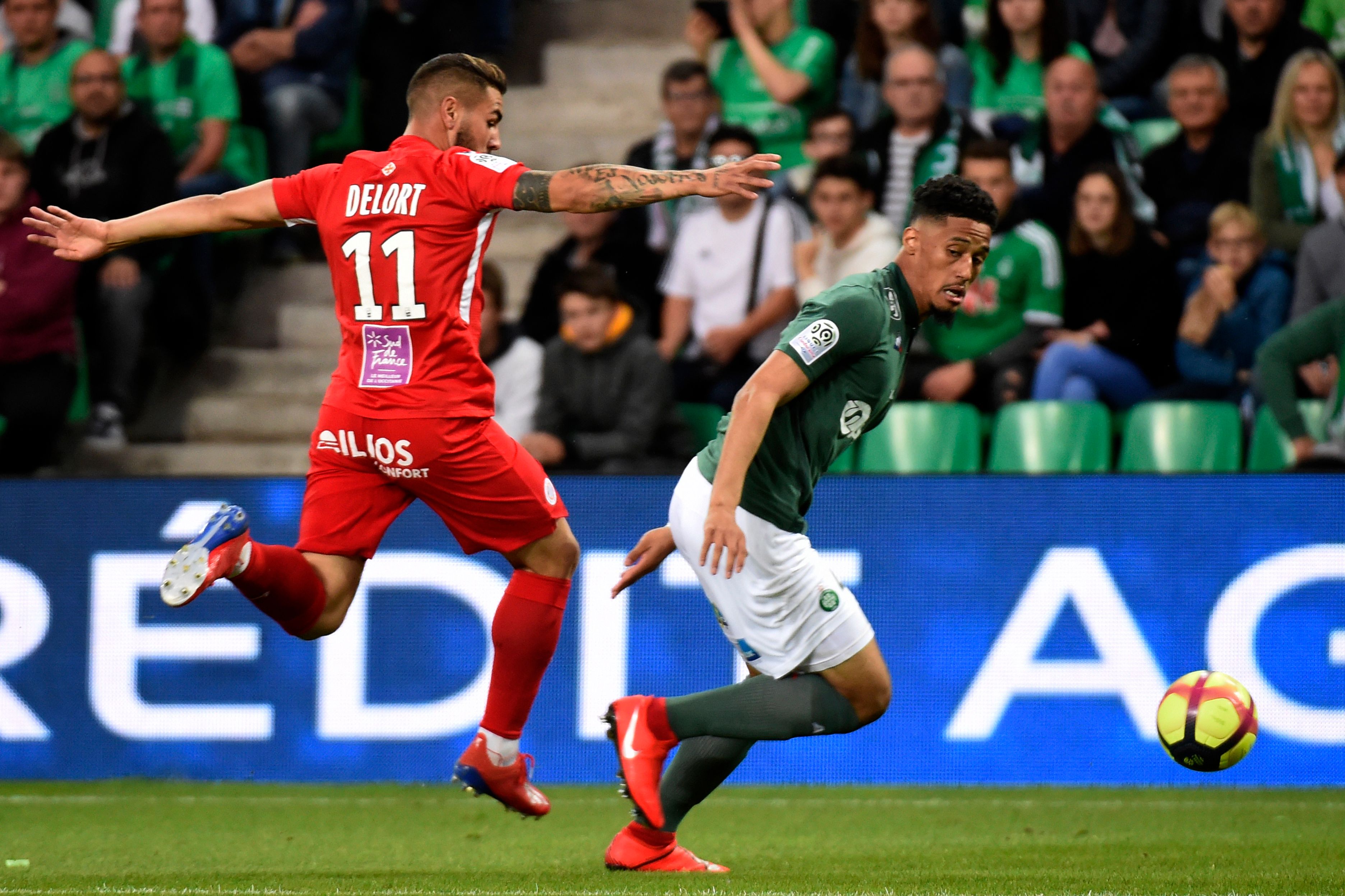 Montpellier's French forward Andy Delfort (L) vies with Saint-Etienne's French forward William Saliba (R) during the French L1 football match between Saint-Etienne (ASSE) and Montpellier (MHSC) on May 10, 2019, at the Geoffroy Guichard Stadium in Saint-Etienne, central France. (Photo by JEAN-PHILIPPE KSIAZEK / AFP)        (Photo credit should read JEAN-PHILIPPE KSIAZEK/AFP/Getty Images)
