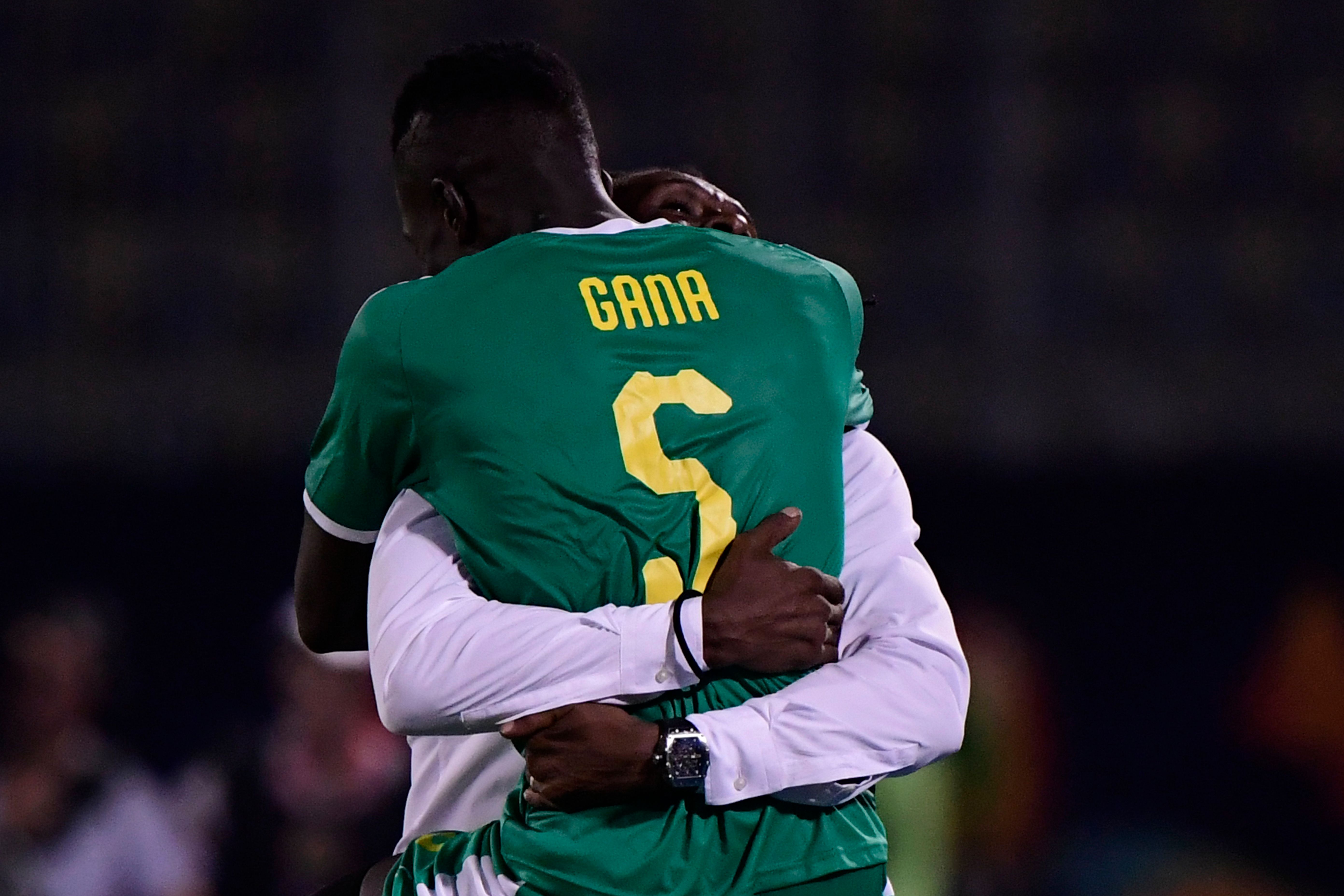 Senegal's midfielder Idrissa Gueye celebrates the win with Senegal's coach Aliou Cisse during the 2019 Africa Cup of Nations (CAN) quarter final football match between Senegal and Benin at the 30 June stadium in Cairo on July 9, 2019. (Photo by JAVIER SORIANO / AFP)        (Photo credit should read JAVIER SORIANO/AFP/Getty Images)