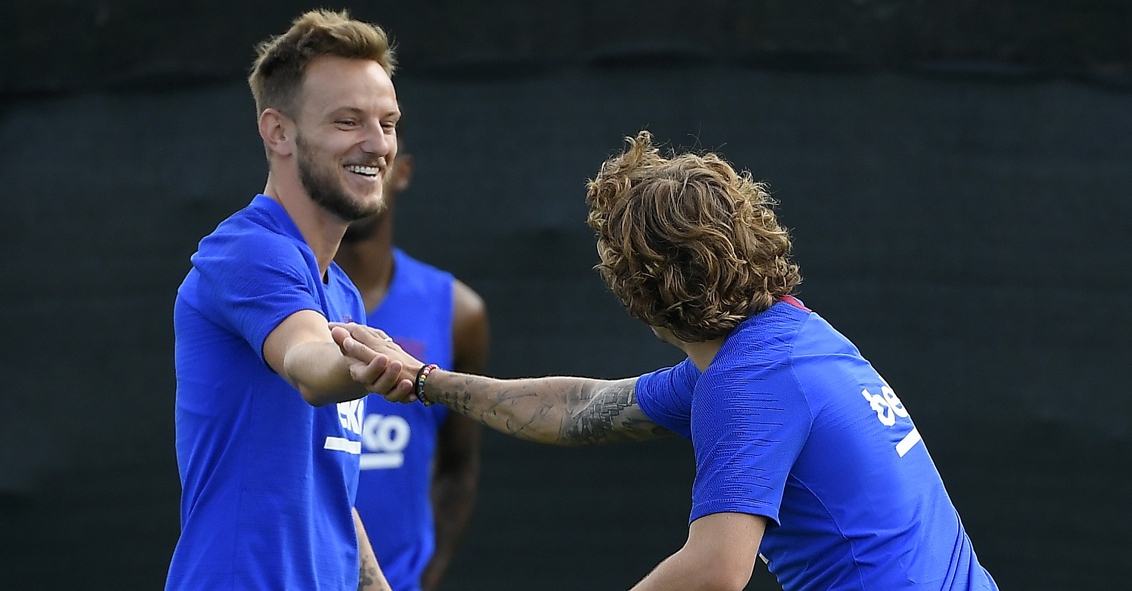Barcelona's French forward Antoine Griezmann (R) jokes with Barcelona's Croatian midfielder Ivan Rakitic during the football club's first pre-season training session at the Joan Gamper training ground in Sant Joan Despi near Barcelona on July 15, 2019. (Photo by LLUIS GENE / AFP)        (Photo credit should read LLUIS GENE/AFP/Getty Images)