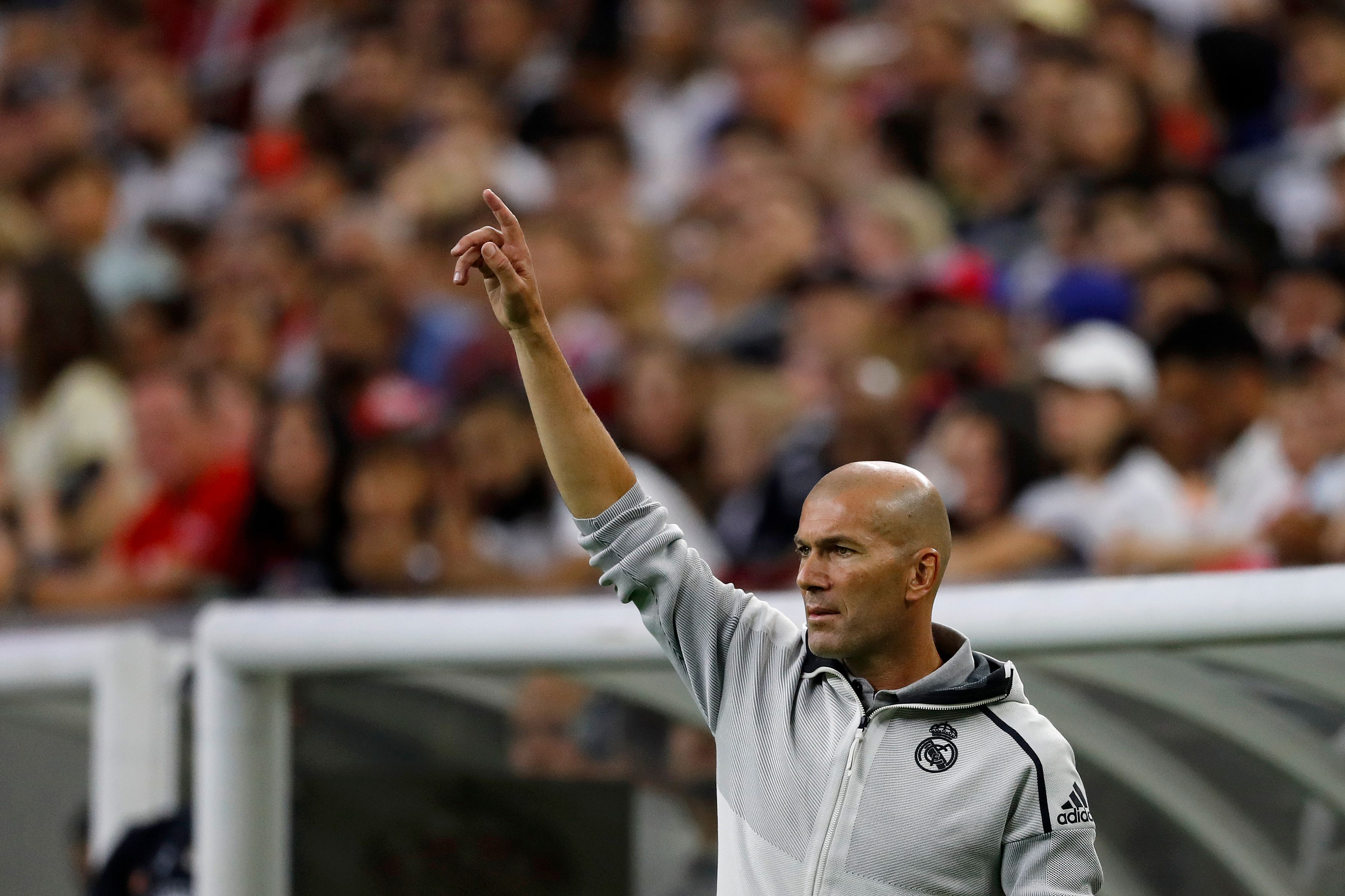 TOPSHOT - Real Madrid head coach Zinedine Zidane coaches against Bayern Munich during their International Champions Cup match on July 20, 2019 at NRG Stadium in Houston, Texas. (Photo by AARON M. SPRECHER / AFP)        (Photo credit should read AARON M. SPRECHER/AFP/Getty Images)