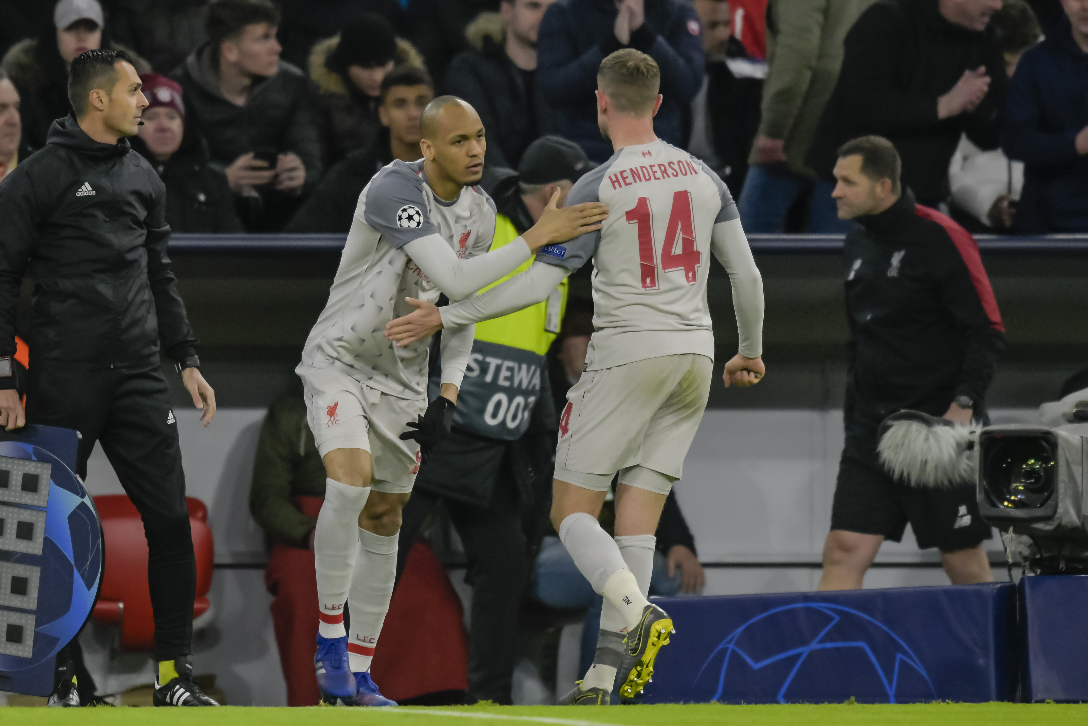 Liverpool's Brazilian midfielder Fabinho comes on for Liverpool's injured English midfielder Jordan Henderson (R) during the UEFA Champions League, last 16, second leg football match Bayern Munich v Liverpool in Munich, southern Germany, on March 13, 2019. (Photo by GUENTER SCHIFFMANN / AFP)        (Photo credit should read GUENTER SCHIFFMANN/AFP/Getty Images)