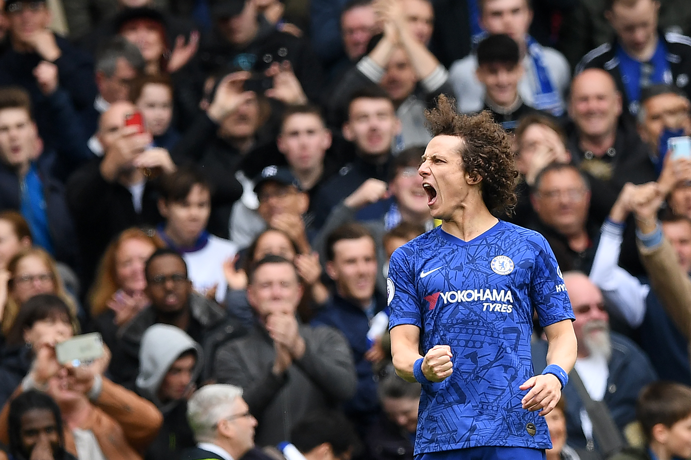 TOPSHOT - Chelsea's Brazilian defender David Luiz celebrates scoring his team's second goal during the English Premier League football match between Chelsea and Watford at Stamford Bridge in London on May 5, 2019. (Photo by Daniel LEAL-OLIVAS / AFP) / RESTRICTED TO EDITORIAL USE. No use with unauthorized audio, video, data, fixture lists, club/league logos or 'live' services. Online in-match use limited to 120 images. An additional 40 images may be used in extra time. No video emulation. Social media in-match use limited to 120 images. An additional 40 images may be used in extra time. No use in betting publications, games or single club/league/player publications. /         (Photo credit should read DANIEL LEAL-OLIVAS/AFP/Getty Images)