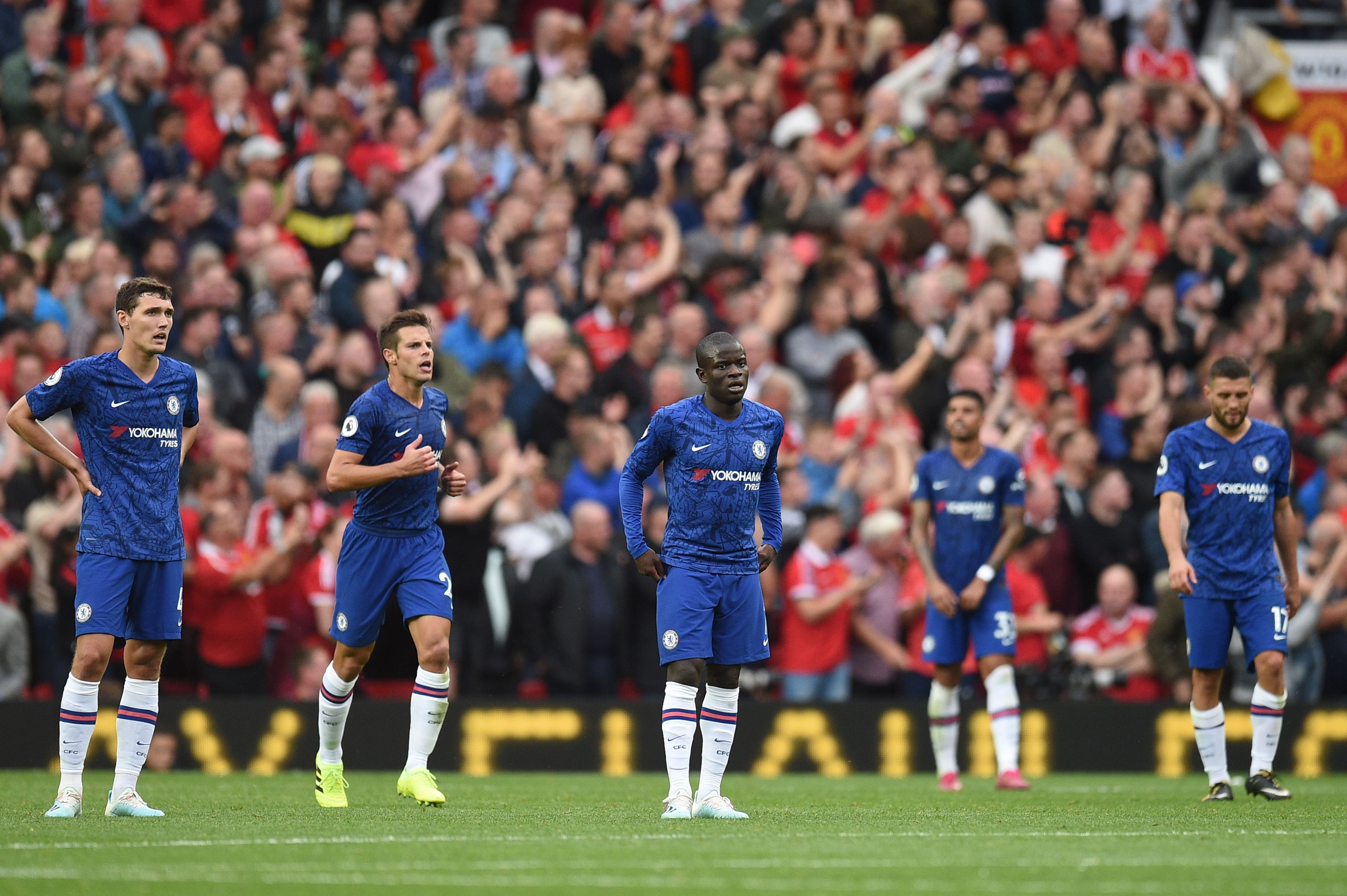 Chelsea players (L-R) Chelsea's Danish defender Andreas Christensen, Chelsea's Spanish defender Cesar Azpilicueta, Chelsea's French midfielder N'Golo Kante, Chelsea's Brazilian-Italian defender Emerson Palmieri and Chelsea's Croatian midfielder Mateo Kovacic reacts to conceding their fourth goal during the English Premier League football match between Manchester United and Chelsea at Old Trafford in Manchester, north west England, on August 11, 2019. - Manchester United won the game 4-0. (Photo by Oli SCARFF / AFP) / RESTRICTED TO EDITORIAL USE. No use with unauthorized audio, video, data, fixture lists, club/league logos or 'live' services. Online in-match use limited to 120 images. An additional 40 images may be used in extra time. No video emulation. Social media in-match use limited to 120 images. An additional 40 images may be used in extra time. No use in betting publications, games or single club/league/player publications. /         (Photo credit should read OLI SCARFF/AFP/Getty Images)