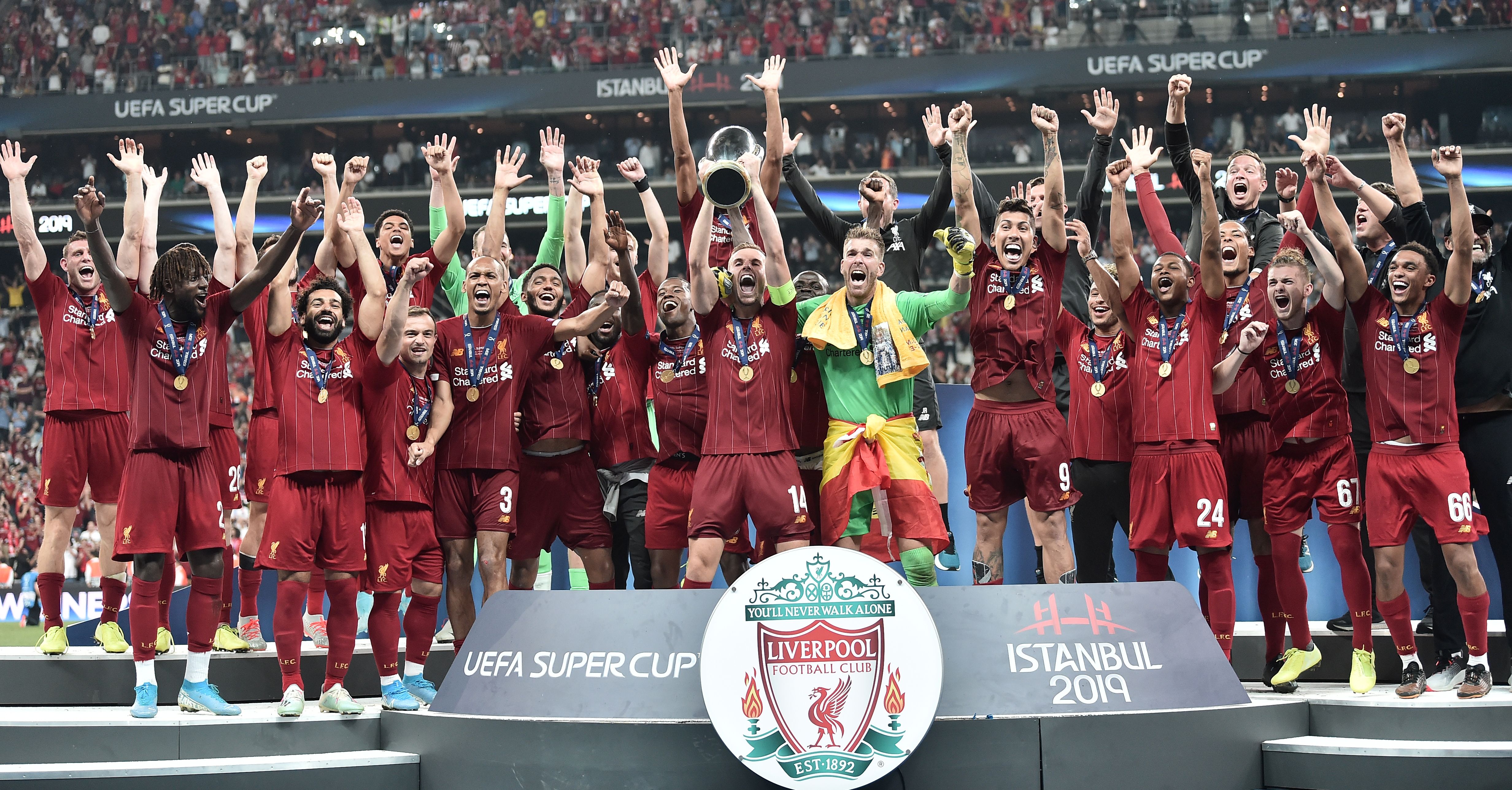Liverpool team poses with the trophy after winning the UEFA Super Cup 2019 football match between FC Liverpool and FC Chelsea at Besiktas Park Stadium in Istanbul on August 14, 2019. (Photo by OZAN KOSE / AFP)        (Photo credit should read OZAN KOSE/AFP/Getty Images)